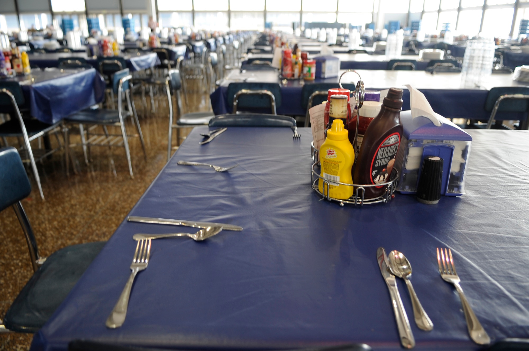 Tables are being set up for lunch Jan. 23 at Mitchell Hall Cadet Dining Facility at the U.S. Air Force Academy in Colorado Springs, Colo. The dining facility feeds approximately 4450 cadets and sits on 1.75 acres. (U.S Air Force photo/Staff Sgt. Desiree N. Palacios)