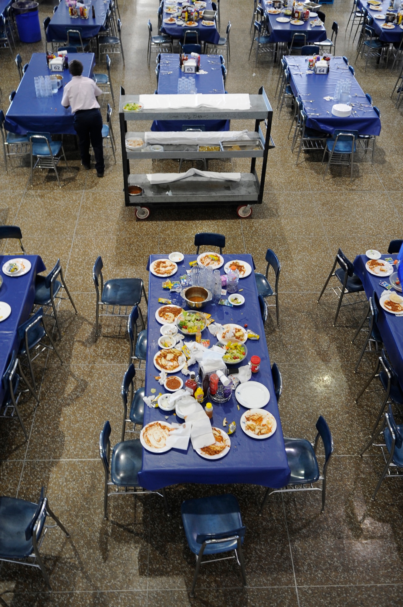 A worker clears off a table after lunch at the Mitchell Hall Cadet Dining Facility Jan. 23 at the U.S. Air Force Academy in Colorado Springs, Colo. The dining facility feeds approximately 4450 cadets and sits on 1.75 acres. (U.S Air Force photo/Staff Sgt. Desiree N. Palacios)