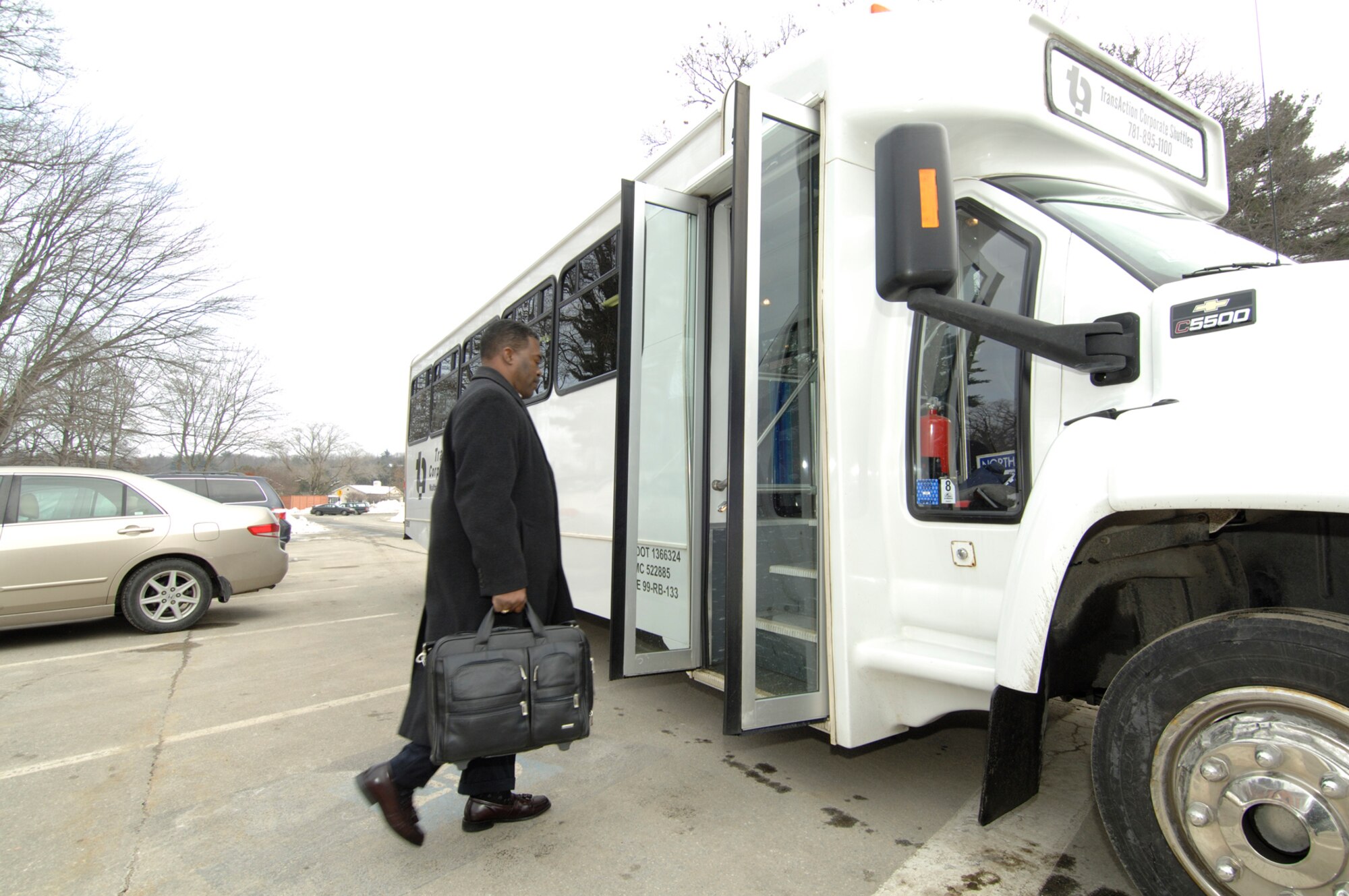 HANSCOM AIR FORCE BASE, Mass. – Galen Williams of the 554th Electronic Systems Wing, boards the new corporate shuttle outside of Building 1600 on Jan. 23. 

TransAction Associates Corporate shuttle is now operating a service Monday to Friday between Nashua and the base. The Shuttle Service pick up, drop off location is the Park and Ride facility at exit 5W off of Route 3 on Route 111. 

Shuttles depart Nashua at 6 a.m. and 7:45 a.m. with arrivals at Hanscom at approximately 6:45 a.m. and 8:30 a.m., respectively. Riders are dropped off and picked up at a location convenient to their work site. Afternoon return shuttles are currently at 4 p.m. and 5:45 p.m. but these schedules can be modified based on actual rider preference. 

The shuttle is available to all Hanscom commuters. To learn more contact Ed Weiner of Transaction Associates at 781-895-1100. (U.S. Air Force photo by Rick Berry)
