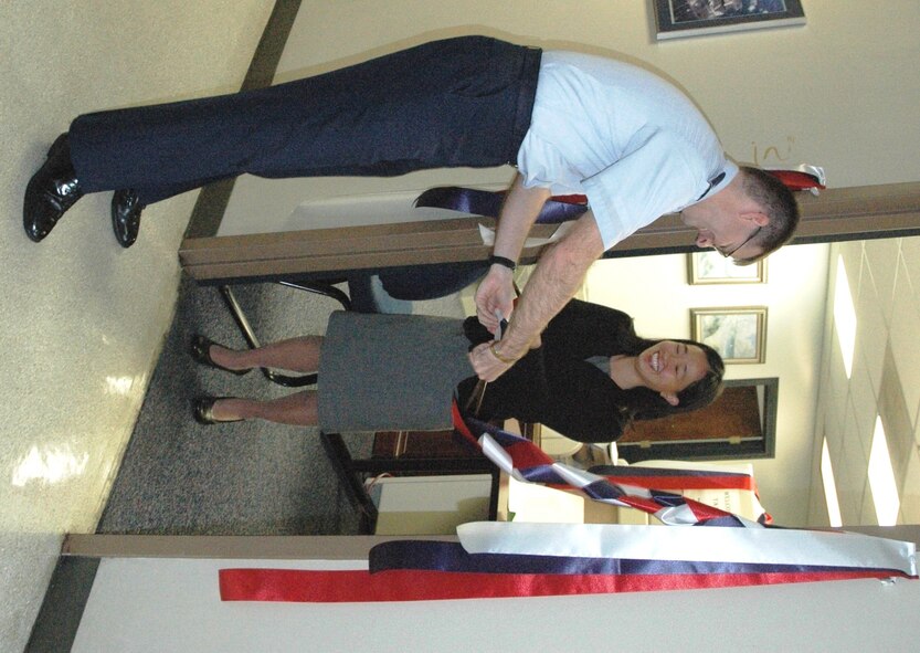 Lt. Col. Daniel Higgins, 325th Fighter Wing Legal Office staff judge advocate, assists Edith Lee, 325th FW Legal Office tax coordinator, in opening the Tyndall Tax Center this morning next to the base legal office.  The Tax Center will be open to assist Tyndall personnel until April 15.   