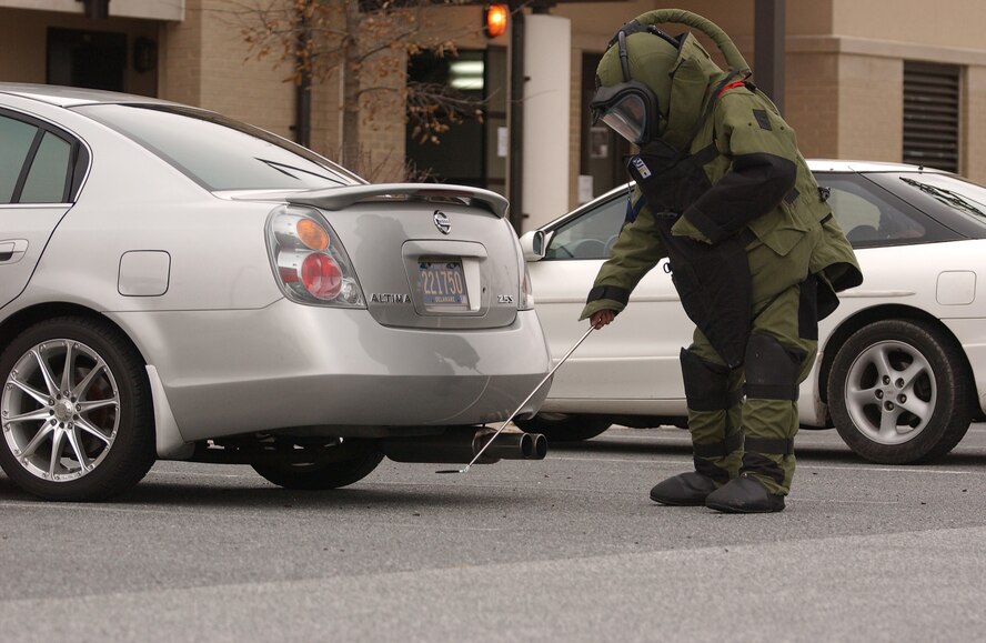 An Explosive Ordnance Disposal Airman searches under a vehicle during a Major Accident Response Exercise on Dover Air Force Base recently. Dover-based EOD Airmen have fought the Global War on Terror, protected the DELMARVA Peninsula from unexploded ordnance, while simultaneously supporting the U.S. Secret Service to protect the President. (Courtesy photo)
