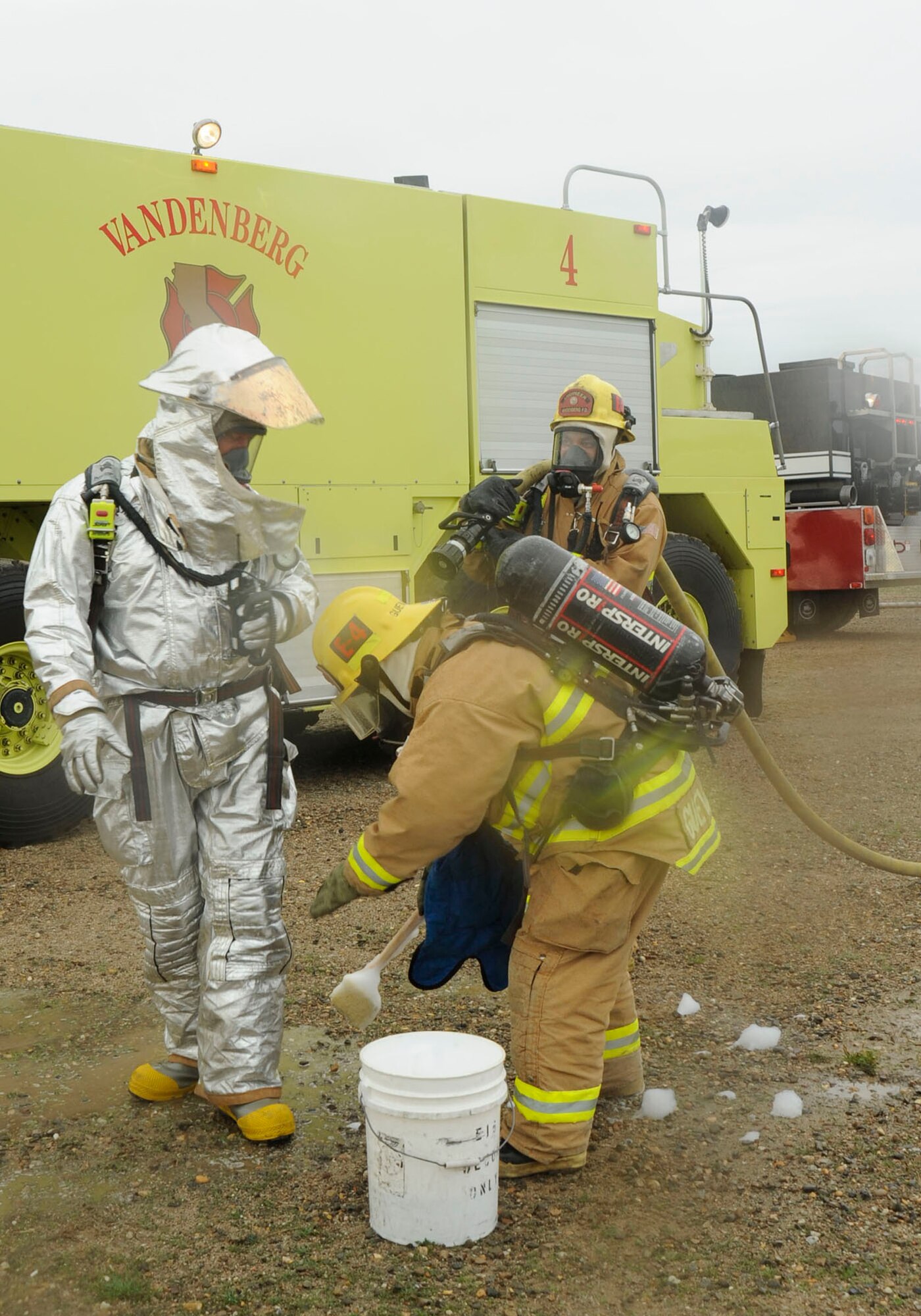 VANDENBERG AIR FORCE BASE, Calif.  -- Members of the 30th Civil Engineer Squadron's fire department go through the decontamination process after putting out flames for an exercise  C-17 Globemaster III crash Jan. 22. The crash was part of a Foggy Shores Exercise that prepares and evaluates the base's performance and response to a real world crisis situation. (U.S Air Force photo/Senior Airman Stephanie Longoria)