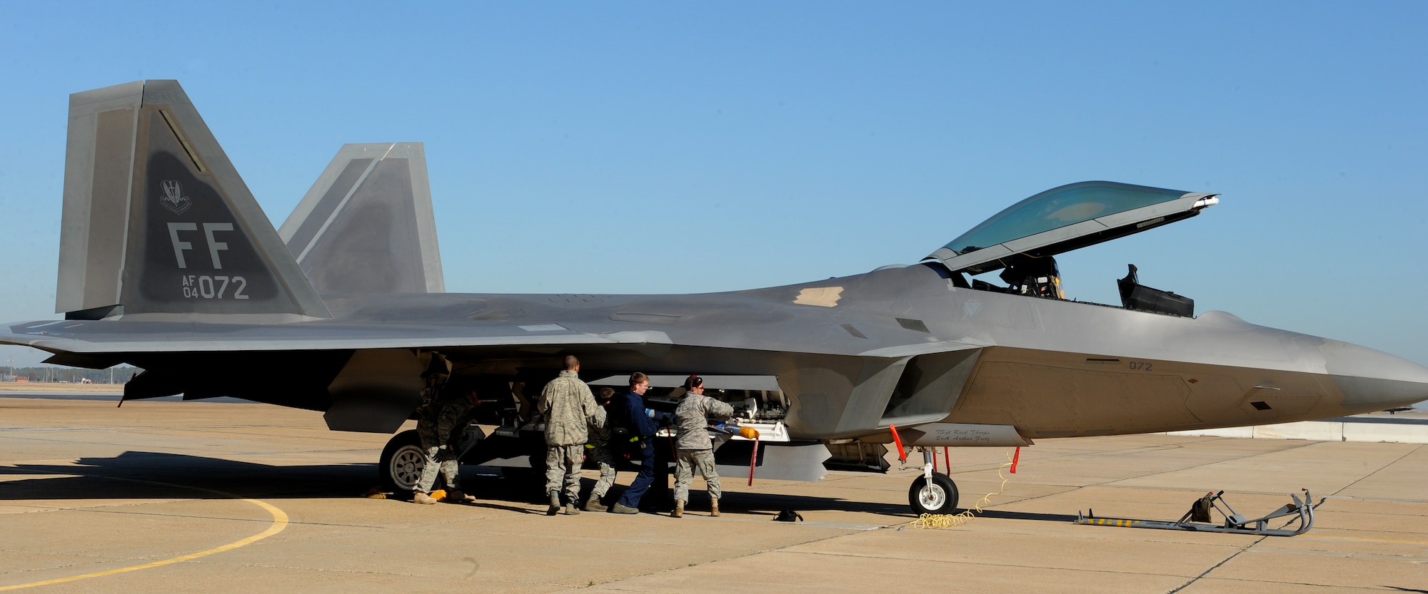 LANGLEY AIR FORCE BASE, Va. -- Staff Sgt. Chris McKee, Airman 1st Class Daniel Aydelotte, and Senior Airman Johnglenn Gararce, 27th Aircraft Maintenance Unit weapons load crew members carry a missile to an F-22 during the competition Jan. 23. Squadron finalists are annually judged on their accuracy, efficiency, and speed. (U.S. Air Force photo/Airman Rebecca Montez)