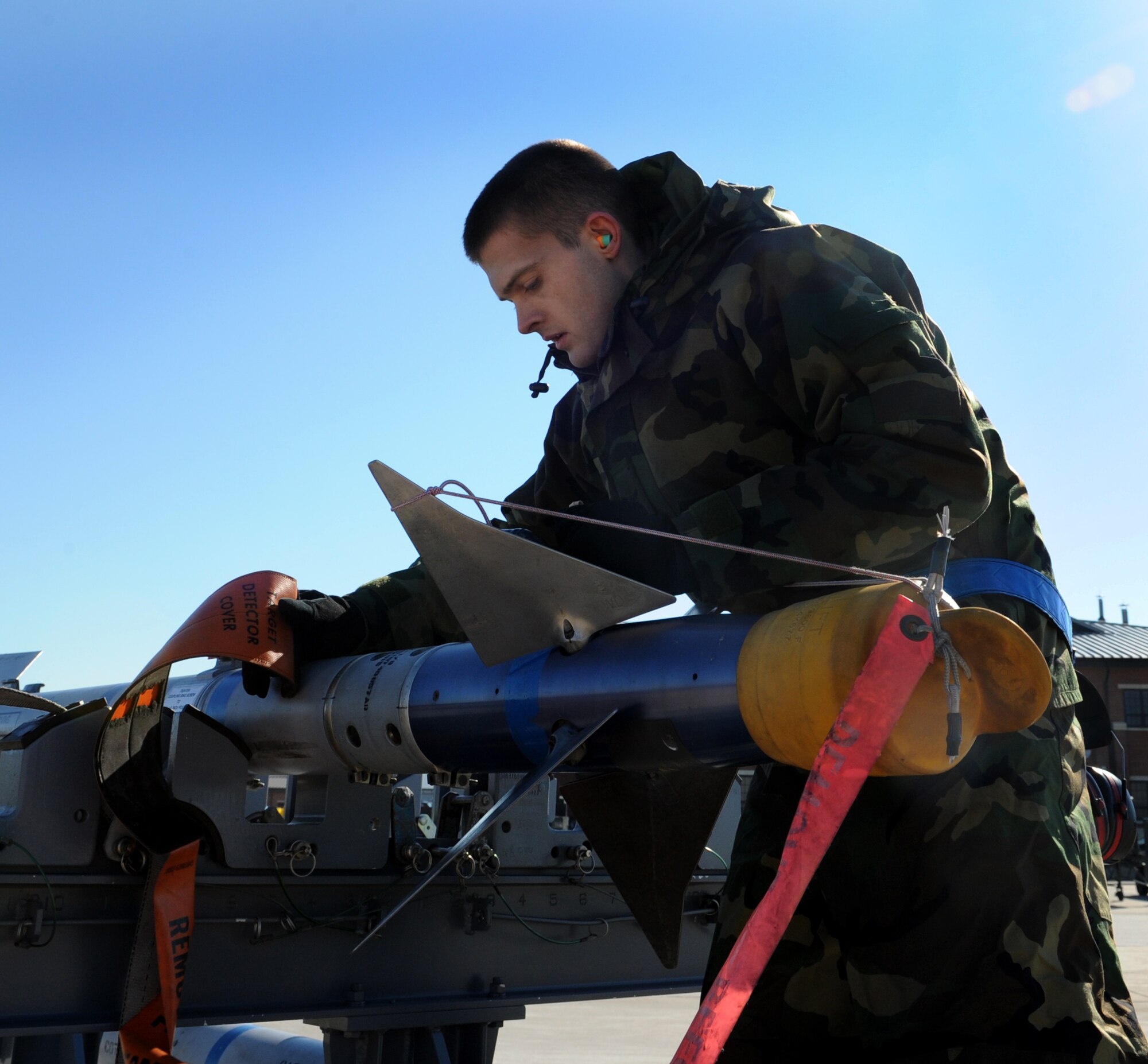 LANGLEY AIR FORCE BASE, Va. -- Airmen 1st Class Jared Joseph, 94th Aircraft Maintenance Unit weapons load crew member inspects a missile as part a competition Jan. 23. Squadron finalists are annually judged on their accuracy, efficiency, and speed.   (U.S. Air Force photo/Airman Rebecca Montez)