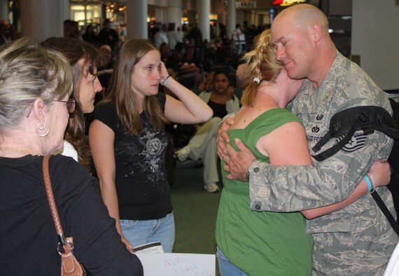 Tech. Sgt. Greg Freeman, 482nd Civil Engineer Squadron explosive ordnance disposal technician, embraces his family after his return to Miami International Airport after a six-month deployment to Afghanistan on Jan. 10. The City of Sarasota resident diffused improvised explosive devices and unexploded ordnance from roadways, cleared weapon caches and performed post-blast analysis missions. Sergeant Freeman served side-by-side with U.S. and Coalition servicemembers in the field, and each mission he and his team accomplished had life-saving consequences. (U.S. Air Force photo/2nd Lt. Erik Hofmeyer)