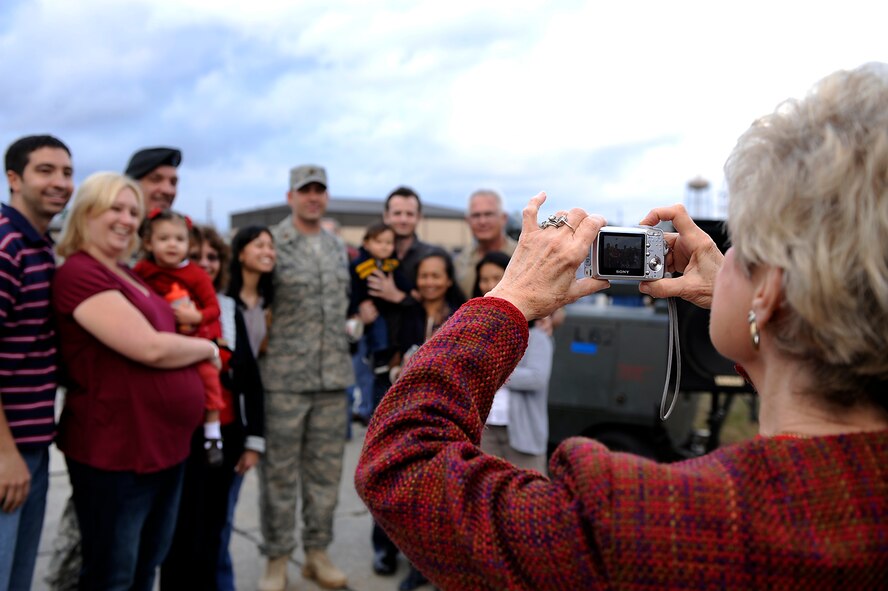 MOODY AIR FORCE BASE, Ga. -- Dr. Lucy Green, long time Moody supporter, takes a photo of a returning member of the 823rd Security Forces Squadron and his family members here Jan. 24. The 823rd SFS arrived home after serving during a deployment to Iraq. (U.S. Air Force photo by Senior Airman Brittany Barker)