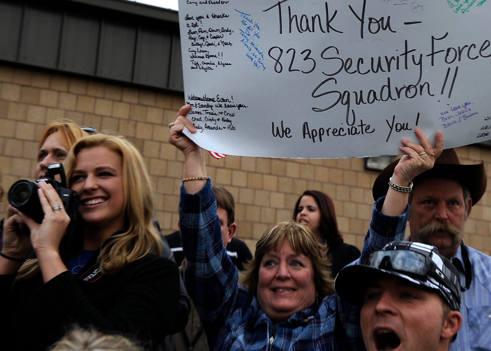 MOODY AIR FORCE BASE, Ga. -- Family members and friends hold welcome home signs while waiting for their loved ones to arrive here Jan. 24. The 823rd SFS arrived home after serving during a deployment to Iraq. (U.S. Air Force photo by Senior Airman Brittany Barker)