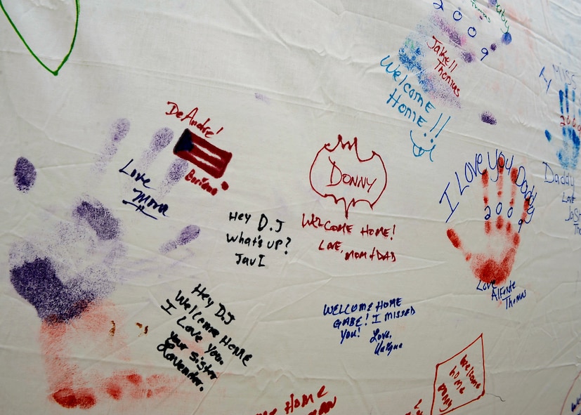 MOODY AIR FORCE BASE, Ga. -- A white sheet filled with messages from family members and loved ones hangs on a fence where the 823rd Security Forces Squadron arrived here Jan 24. The 823rd SFS arrived home after serving during a deployment to Iraq. (U.S. Air Force photo by Senior Airman Brittany Barker)