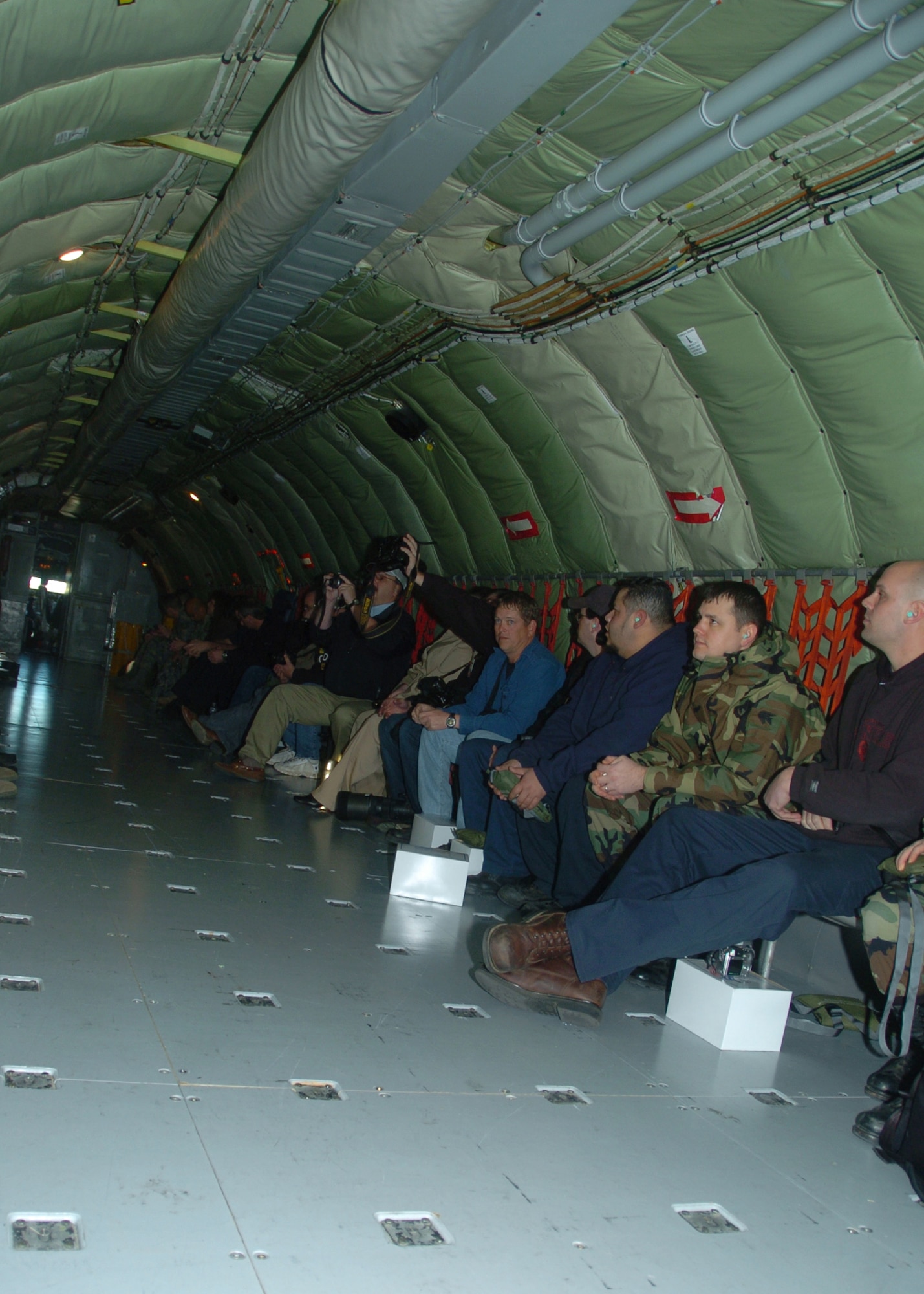 ALTUS AIR FORCE BASE, Okla. -- Newsgroups from both Altus and Wichita Falls fly in a KC -135 during a Crisis Communication Exercise Jan. 22. Each passenger had the opportunity to go in the boom pod and watch as the KC-135 refueled a C-17 Globemaster. (U.S. Air Force photo/ Airman 1st Class Tiffany M. Deuel)

