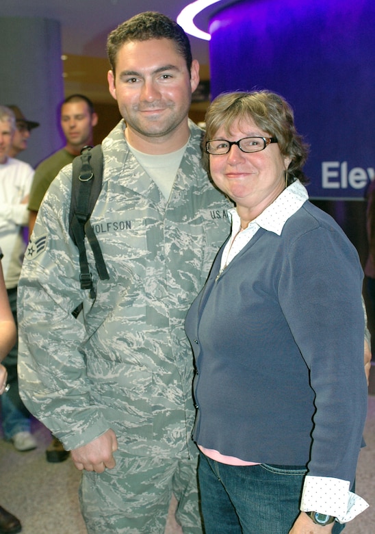 Senior Airman Brent Wolfson reunites with his mother Lynn Harrill who traveled to Tucson from Glendale, Calif., to welcome her son home. Family and friends crowded the baggage claim area at Tucson International Airport to welcome home 28 aircraft maintainers and pilots Jan. 24. The Guardsmen volunteered for tours ranging from 8 months to 30 days in duration. They were given a standing ovation from travelers in the terminal on their way to baggage claim. (Air National Guard photo by Capt. Gabe Johnson)