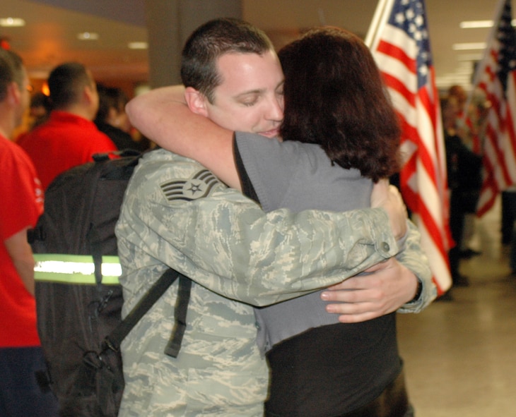Staff Sgt. TJ Dodson hugs his girlfriend Leta Oranski. Family and friends crowded the baggage claim area at Tucson International Airport to welcome home 28 aircraft maintainers and pilots Jan. 24. The Guardsmen volunteered for tours ranging from 8 months to 30 days in duration. They were given a standing ovation from travelers in the terminal on their way to baggage claim. (Air National Guard photo by Capt. Gabe Johnson)