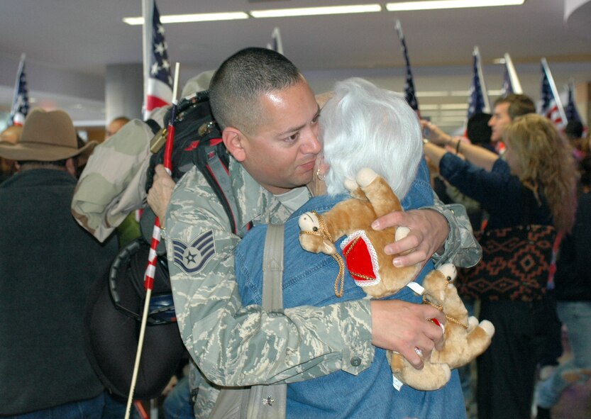 Staff Sgt. Frank Rendon hugs a family member. Family and friends crowded the baggage claim area at Tucson International Airport to welcome home 28 aircraft maintainers and pilots. The Guardsmen volunteered for tours ranging from 8 months to 30 days in duration. (Air National Guard photo by Capt. Gabe Johnson)