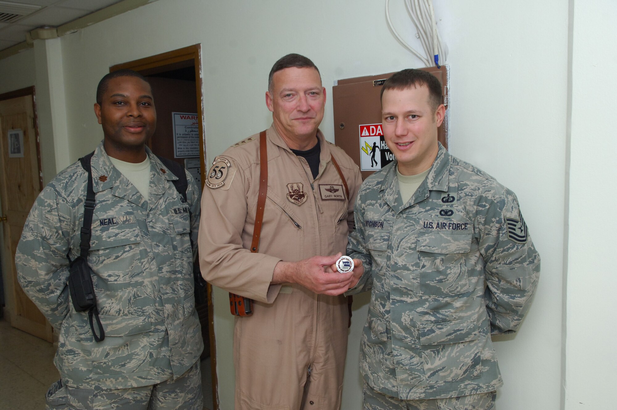 Tech Sgt. Jason Hutchison, right, gets coined by Lt. Gen. Gary North, Air Force Central Command commanding general, at Joint Base Balad late December.  Sergeant Hutchison is currently deployed from Keesler Air Force Base’s 81st Comptroller Squadron in support of Operation Iraqi Freedom.  Sergeant Hutchison manages over 2000 lines of accounting daily along with seeing to the timely payment to Iraqi, Turkish and United States-based vendors.  (Courtesy photo)

