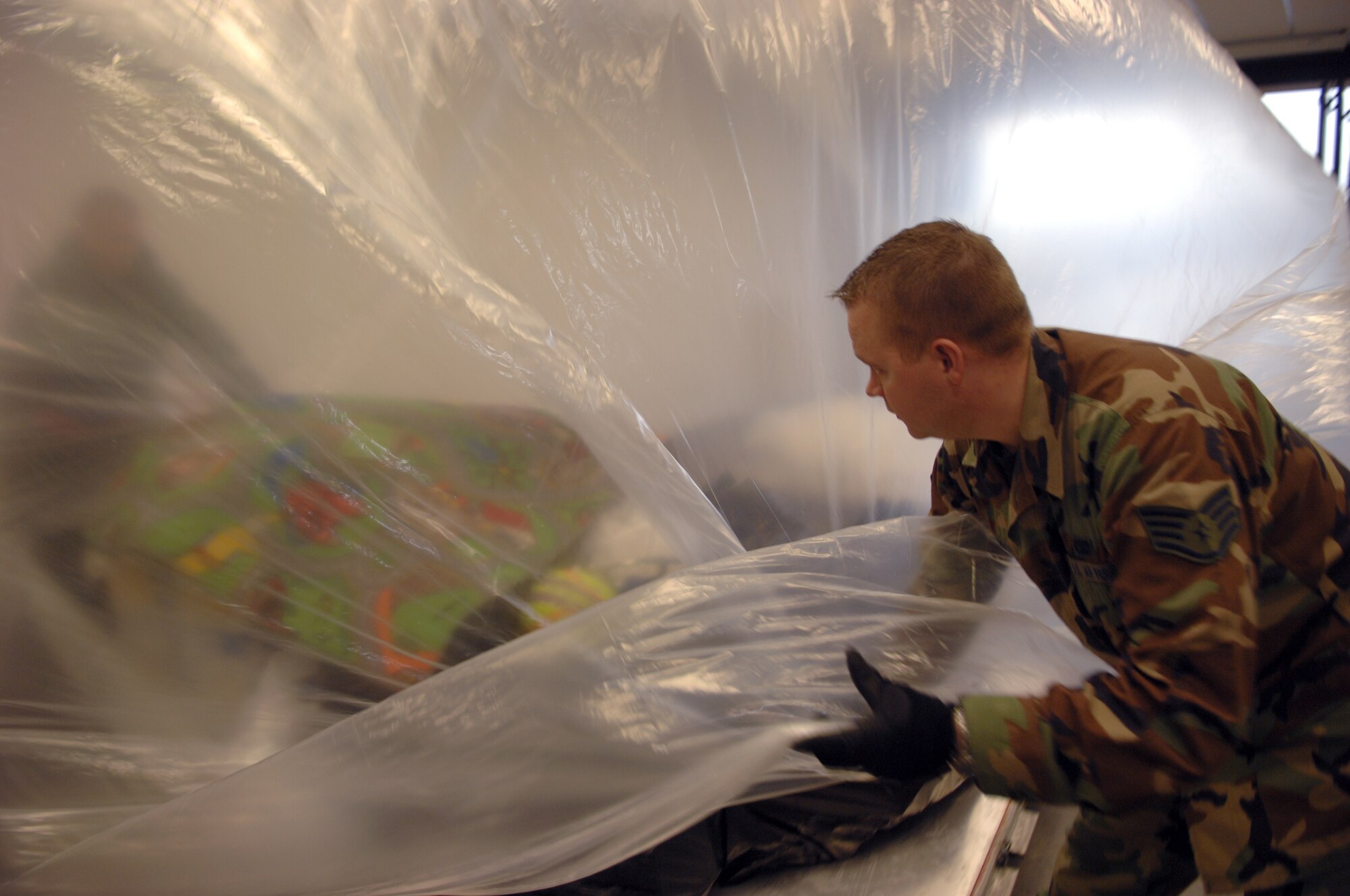 Staff Sgt. Jess Knutson, 435th Logistics Readiness Squadron air transportation, palletizes toys being donated to an orphanage in Poland Jan. 23, 2009, at Ramstein Air Base. The Kaiserslautern Military Community 5/6 Club organized the donation. (U.S. Air Force photo by Senior Airman Amber Bressler)