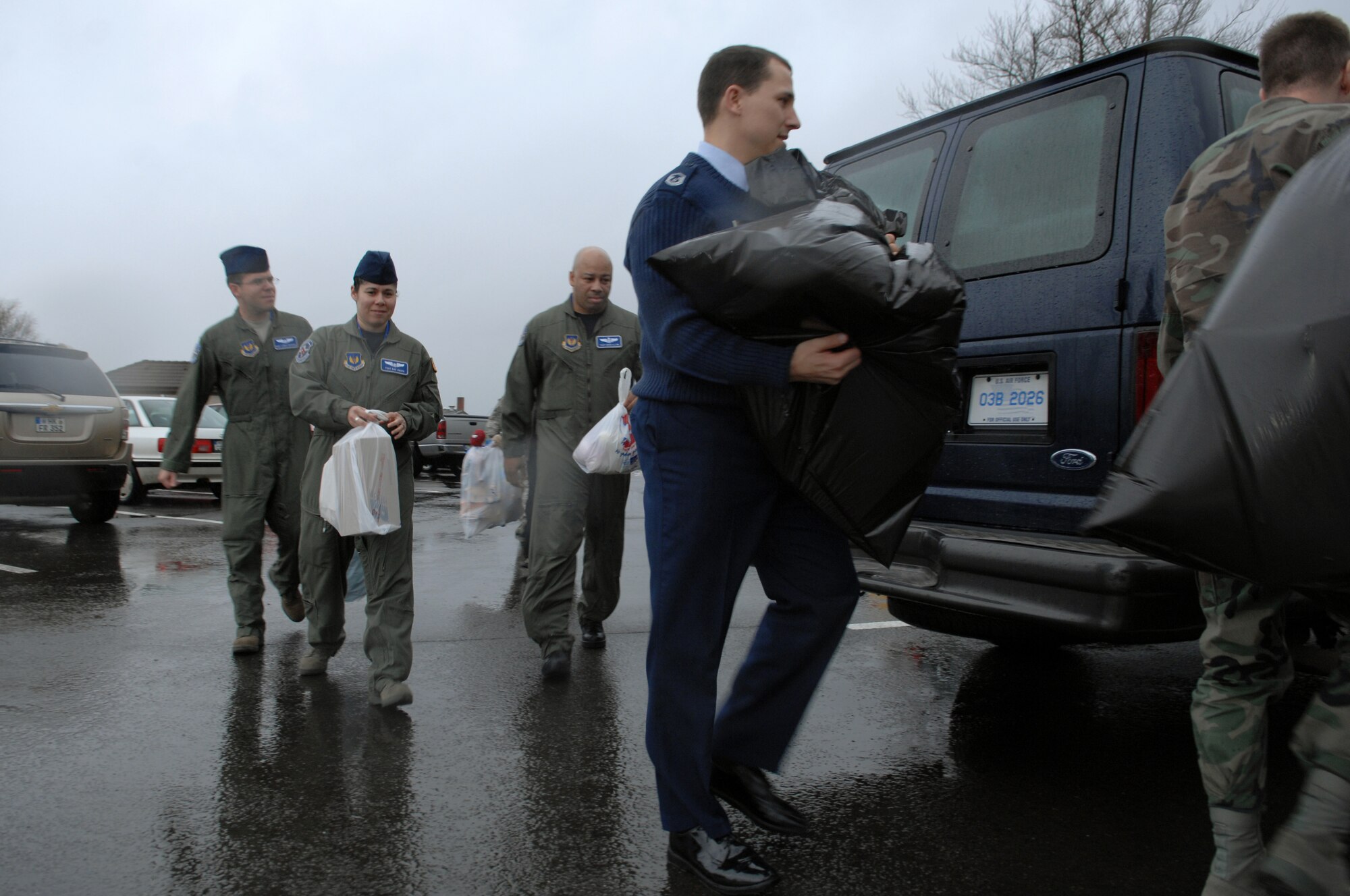 Members from the 86th Aeromedical Evacuation Squadron help carry bags of toys being donated to kids Jan. 23, 2009, at Ramstein Air Base. The toys will be donated to an orphanage in Poland. (U.S. Air Force photo by Senior Airman Amber Bressler)