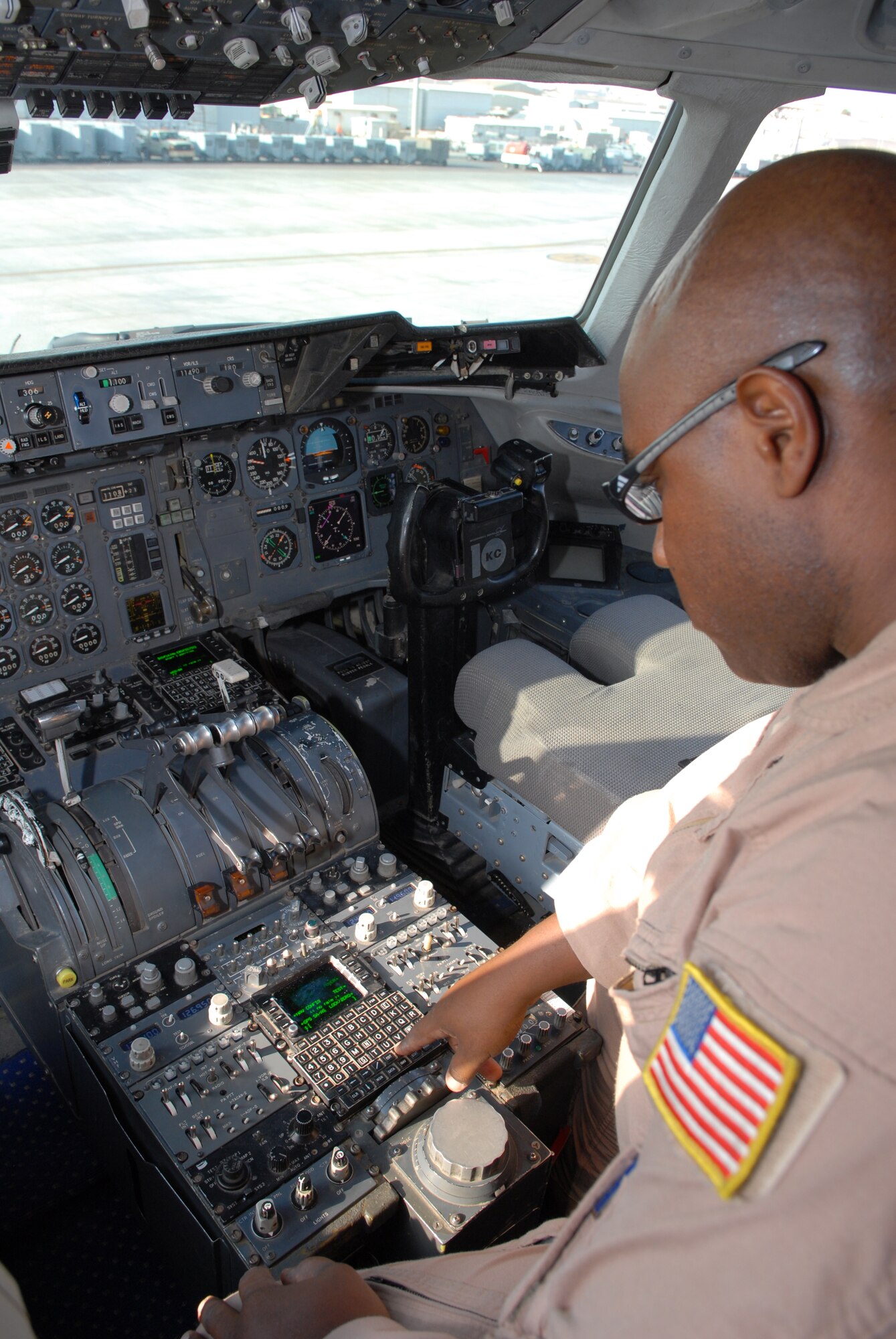 SOUTHWEST ASIA - Master Sgt. Terence Jackson, 908 Expeditionary Air Refueling Squadron, flight engineer, performs the pre-flight inspection on the Flight Management System Control Display Unit, Jan 23. Sergeant Jackson reached a milestone of 10,000 flight hours. Sergeant Jackson is deployed from the 305th Air Mobility Wing, McGuire AFB and is from Grand Rapids, Mich. (U.S. Air Force photo by Captain Jennifer M. Pearson) (Released)