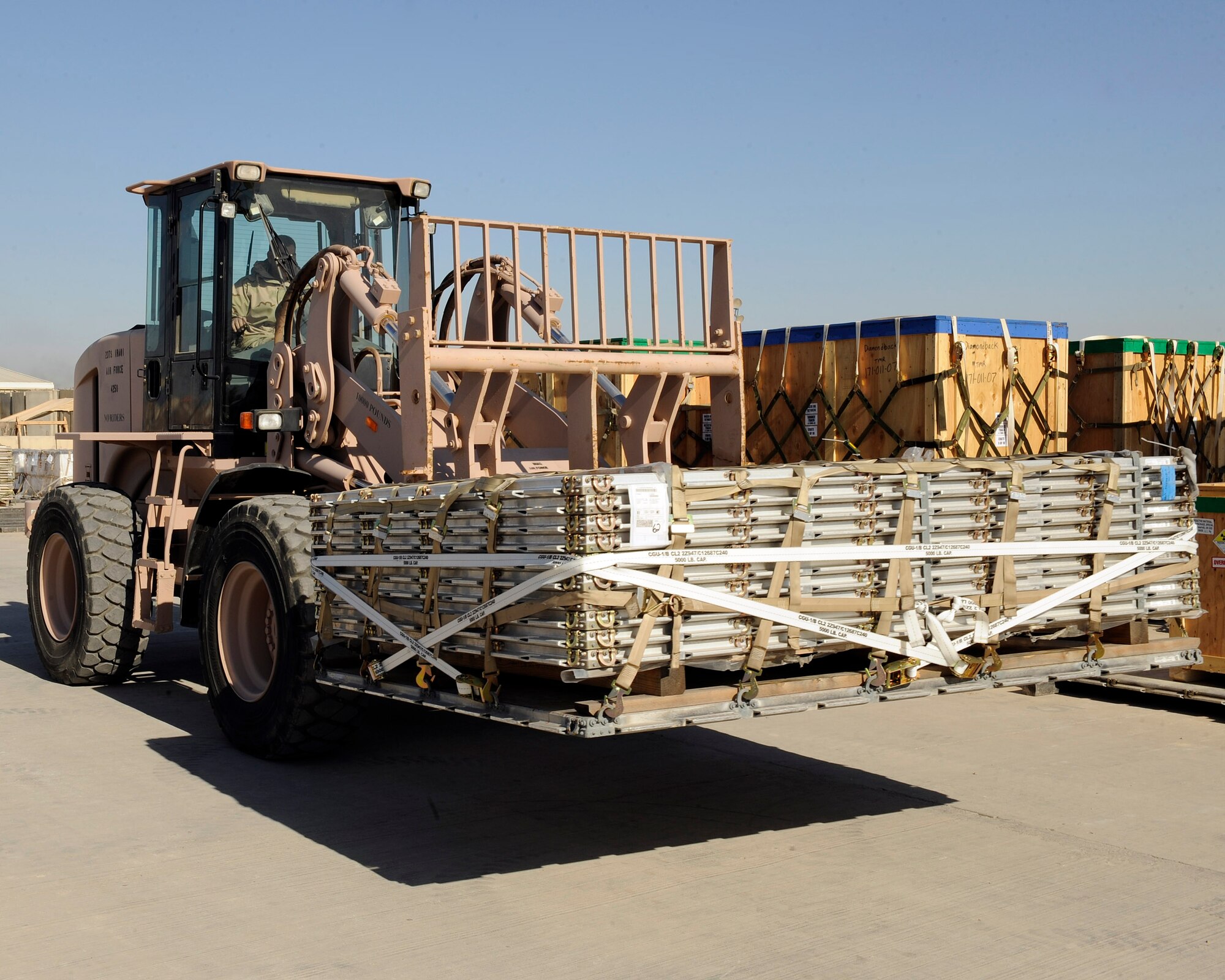 Sualla, Iraqi air force, moves the first pallets to be received by the Iraqi air force. The pallet’s arrival at Sather Air Base is a test of the new Iraqi logistical readiness system at New Al Muthana AB, Iraq Jan. 23. (U.S. Air Force photo by Senior Airman Jacqueline Romero)