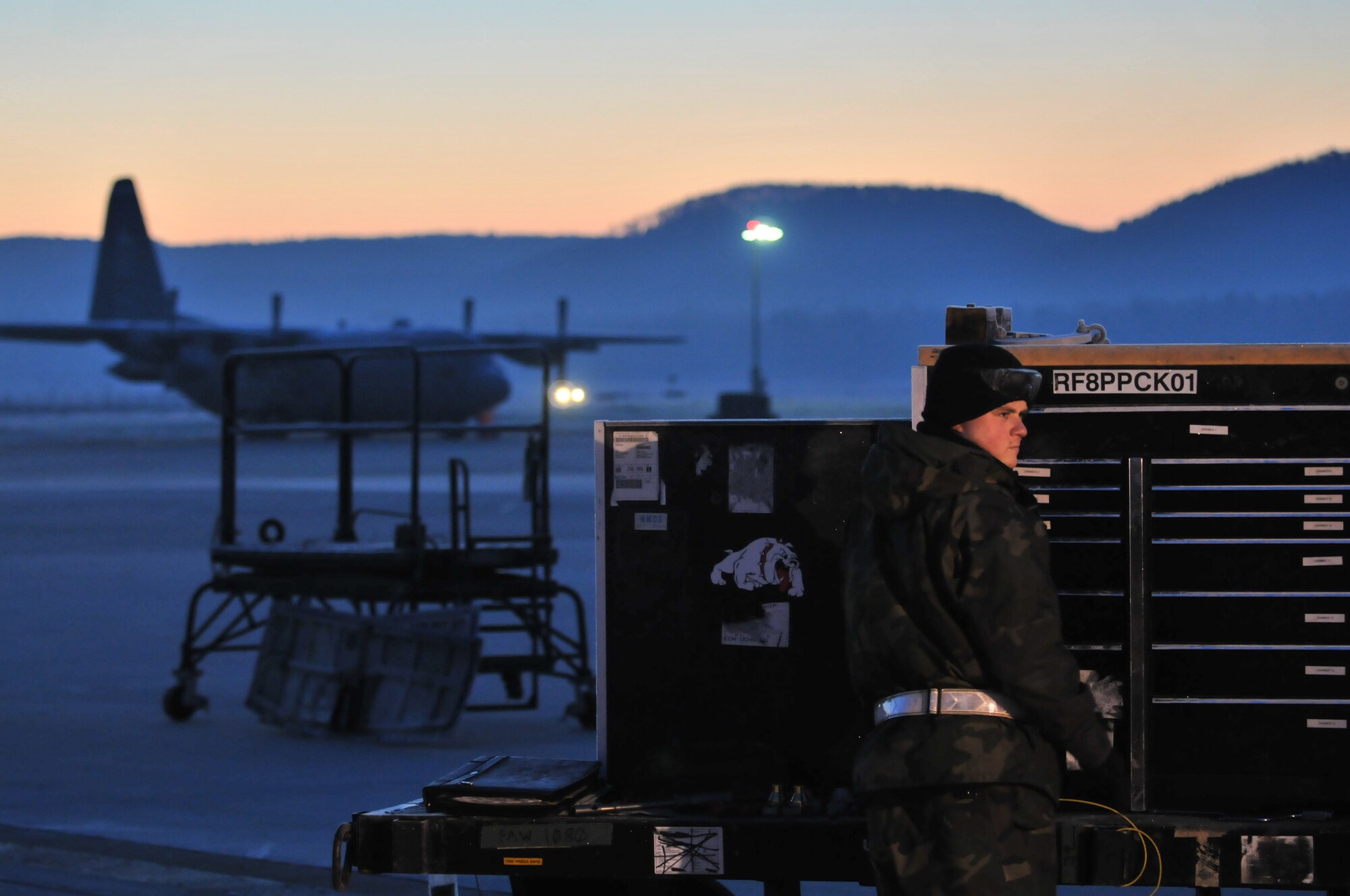 Senior Airman Jerry Tolbert, 86th Aircraft Maintenance Squadron, retrieves a wrench from his tool box in the early morning while working on a C-130 Hercules Jan. 22, 2009, at Ramstein Air Base. (U.S. Air Force photo by Senior Airman Nathan Lipscomb)