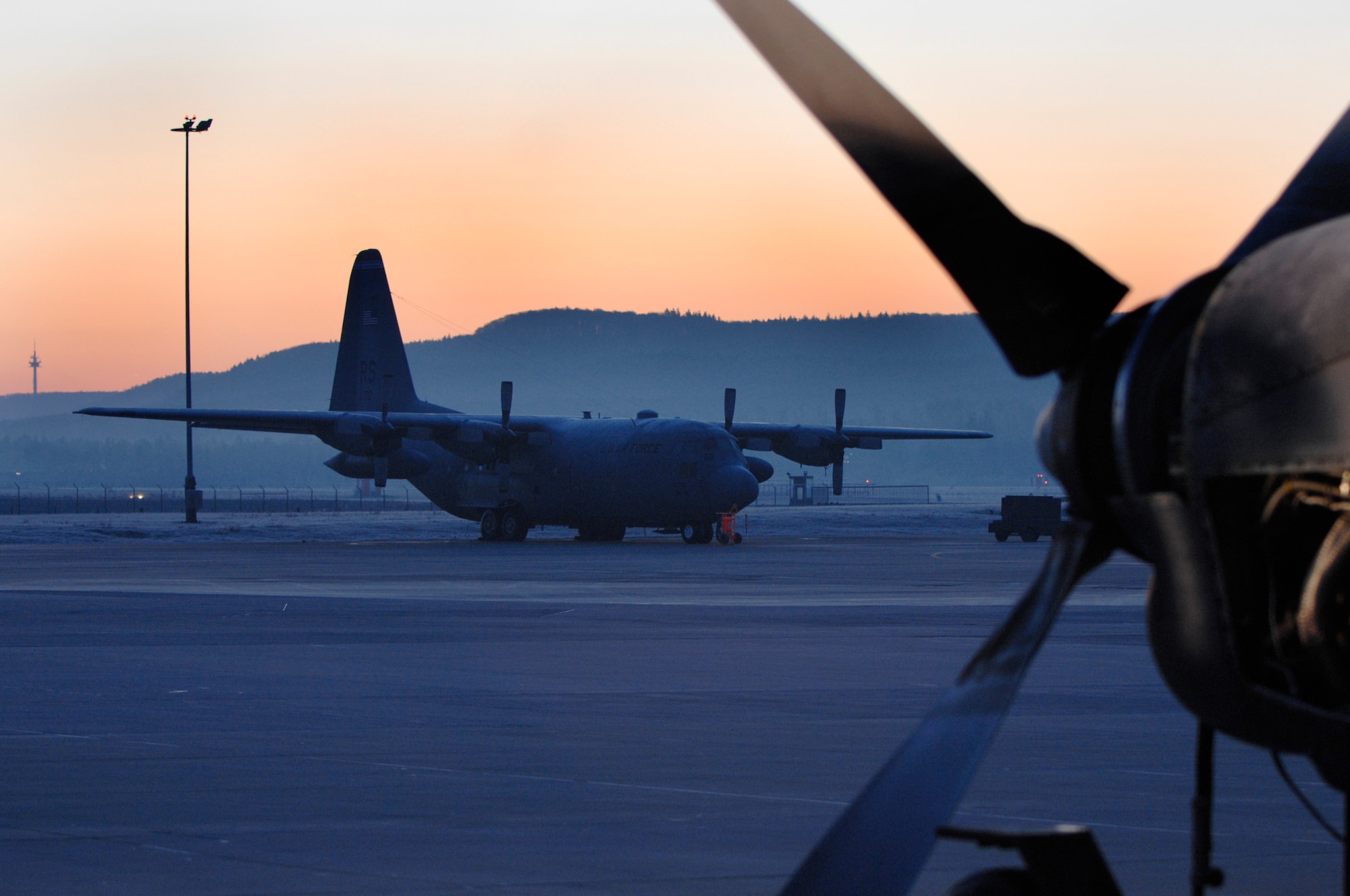 A C-130 Hercules aircraft awaits maintenance from the 86th Aircraft Maintenance Squadron aircraft maintainers Jan. 22, 2009, at Ramstein Air Base. Rain or shine, the maintainers keep their "birds" running safely. (U.S. Air Force photo by Senior Airman Amber Bressler)