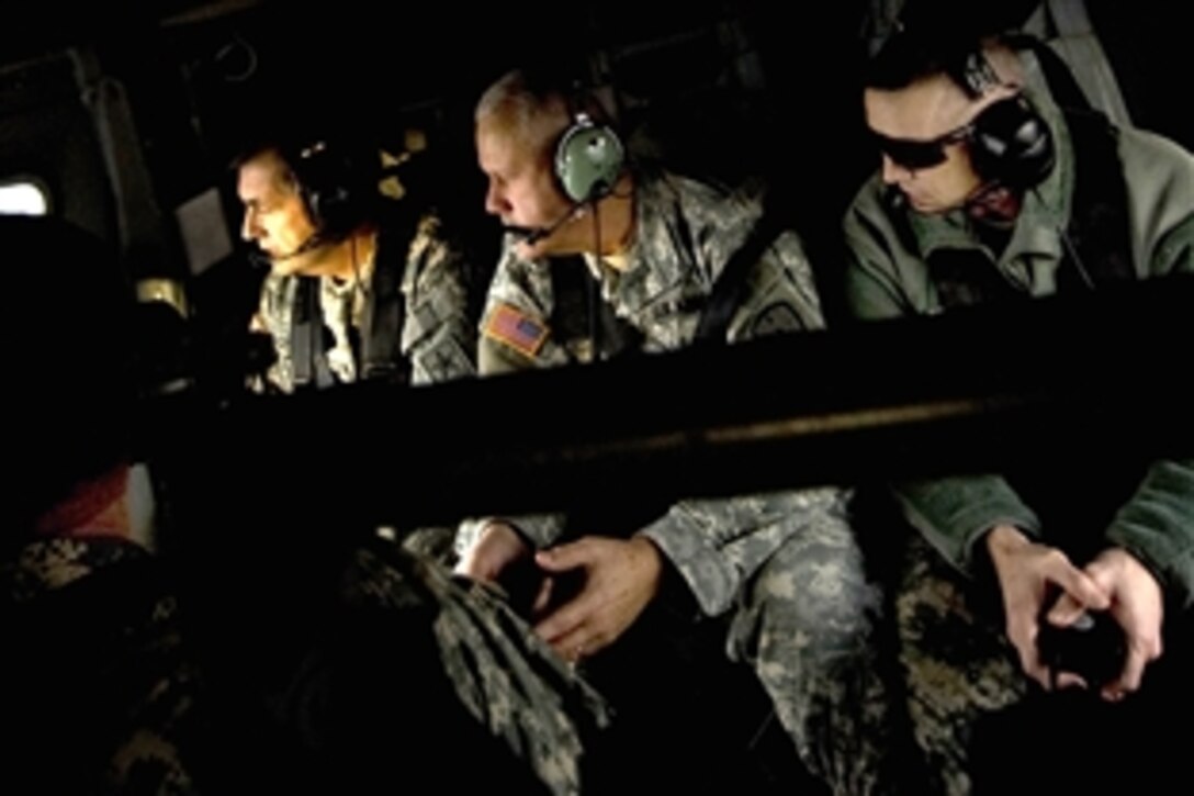 U.S. Army Gen. Peter Chiarelli, the Army's vice chief of staff, Maj. Gen. Martin Umbarger, adjutant general of Indiana, and Maj. Gen. Michael Bednarek, commanding general of the First Army Division East, review training facilites as they fly over Camp Atterbury, Ind., Jan. 23, 2009.