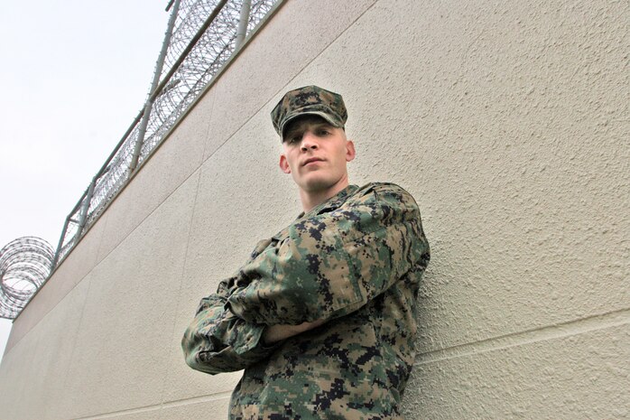 Lance Cpl. Noah Rosenthal, a Provost Marshals office correctional specialist at the brig here, stands outside the barbwire fencing that retains all inhabiting prisoners. His educational background and professionalism have his superiors directing him towards the officer program. Unsure, Rosenthal is also considering a career in the military’s Criminal Investigation Department.