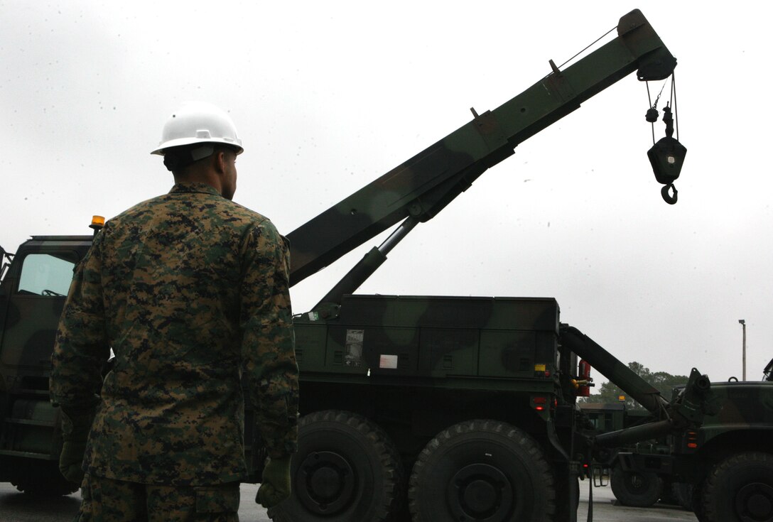 Lance Cpl. Luis Rolon, a motor transportation operator from General Support Motor Transport Company, Combat Logistics Regiment 2, 2nd Marine Logistics Group, assists in operating a 7-ton wrecker truck, here, Jan. 27.  Rolon and a majority of the Marines from GSMT Company are preparing to deploy to both Iraq and Afghanistan later this year.