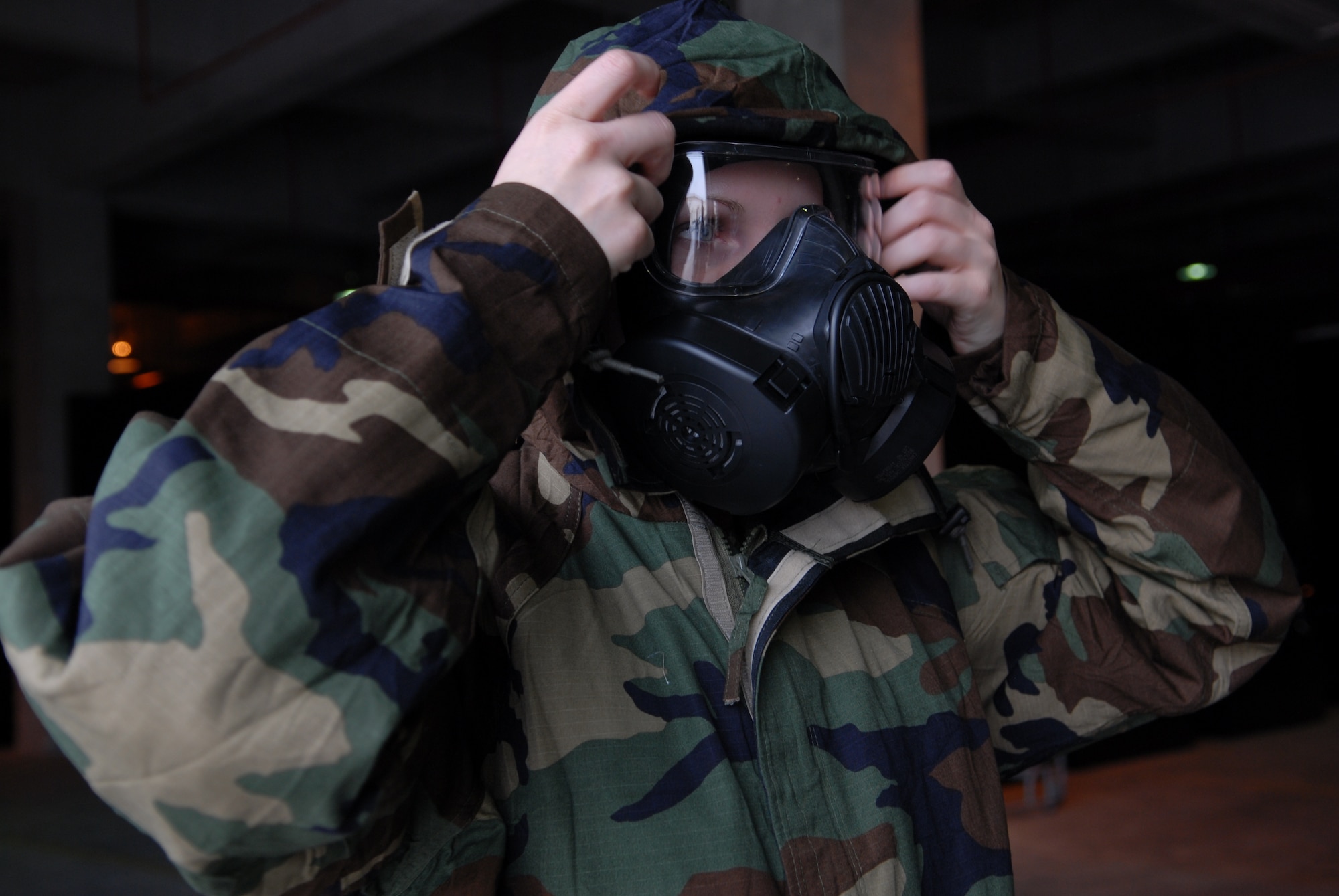Amn. Heather Landvatter, Individual Protective Equipment flight, 18th Logistics Readiness Squadron, Kadena Air Base, Japan, tries on the new M-50 gas mask as her shop prepares for a base-wide distribution of the new equipment beginning March1, 2009.
(U.S. Air Force photo/Staff Sgt Angelique Perez)
