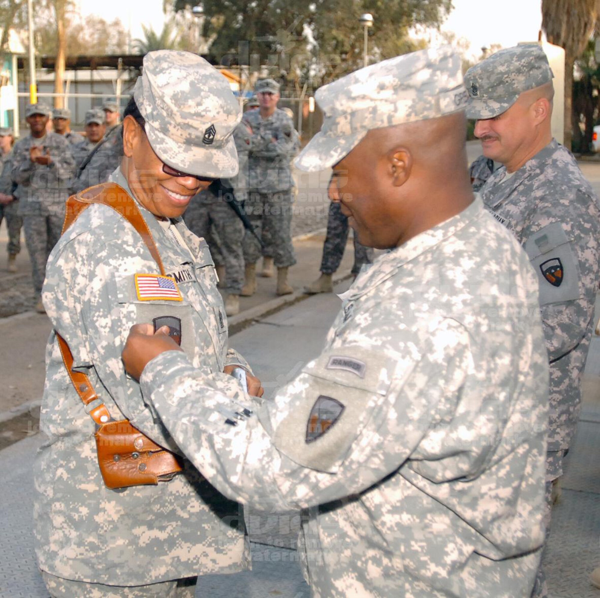 1st Sgt. Gail Smith, Headquarters and Headquarters Company 304th Sustainment Brigade first sergeant, receives her combat patch from Lt. Col. Norman Green, the 304th Sust. Bde. commander. The 304th Sust. Bde., an Army Reserve component unit based out of March ARB is one of 35 sustainment brigades in the Army  configured to support the Army’s rapidly changing combat and support structure. (Courtesy photo to U.S. Air Force) 