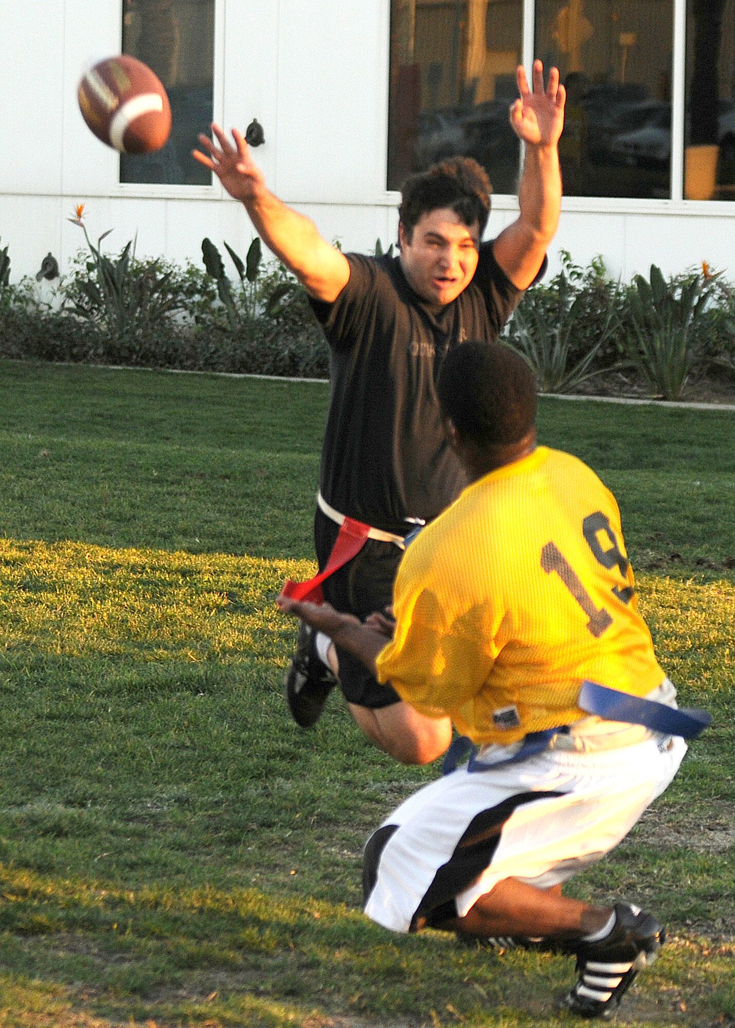 Mike Moore (in black), Team Aerospace, makes a play for the ball in hopes of deflecting a pass thrown to Master Sgt. Shayne Pratt, 61st Medical Group, during their game in the Intramural Flag Football Championship, Jan. 15. The Medical Group won 38-31. (Photo by Stephen Schester)