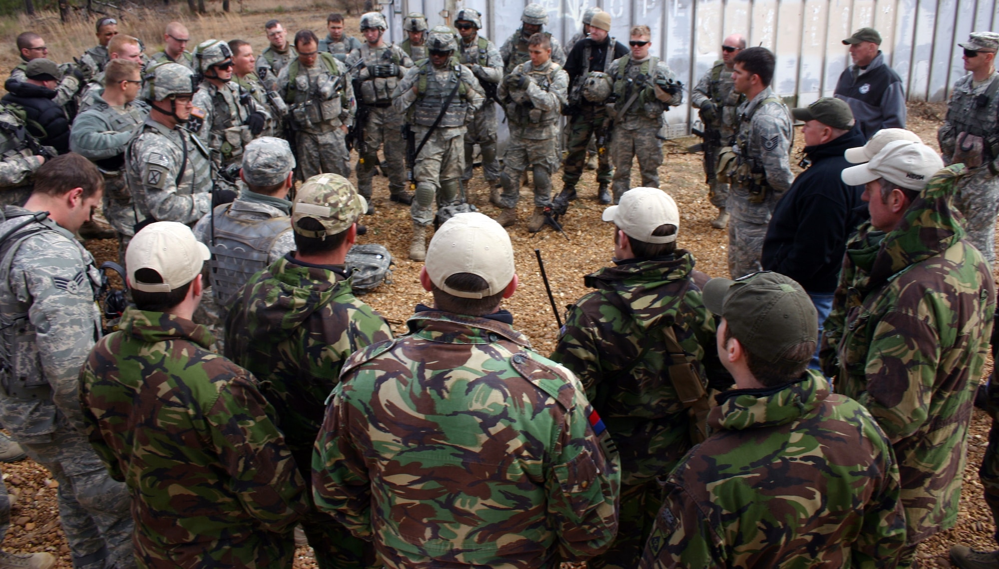 American Airmen and British joint terminal attack controllers and U.S. Army joint fires observers conduct an after action report at the Joint Readiness Center in Fort Polk, La. (U.S. Air Force photo/Casey Bain) 
