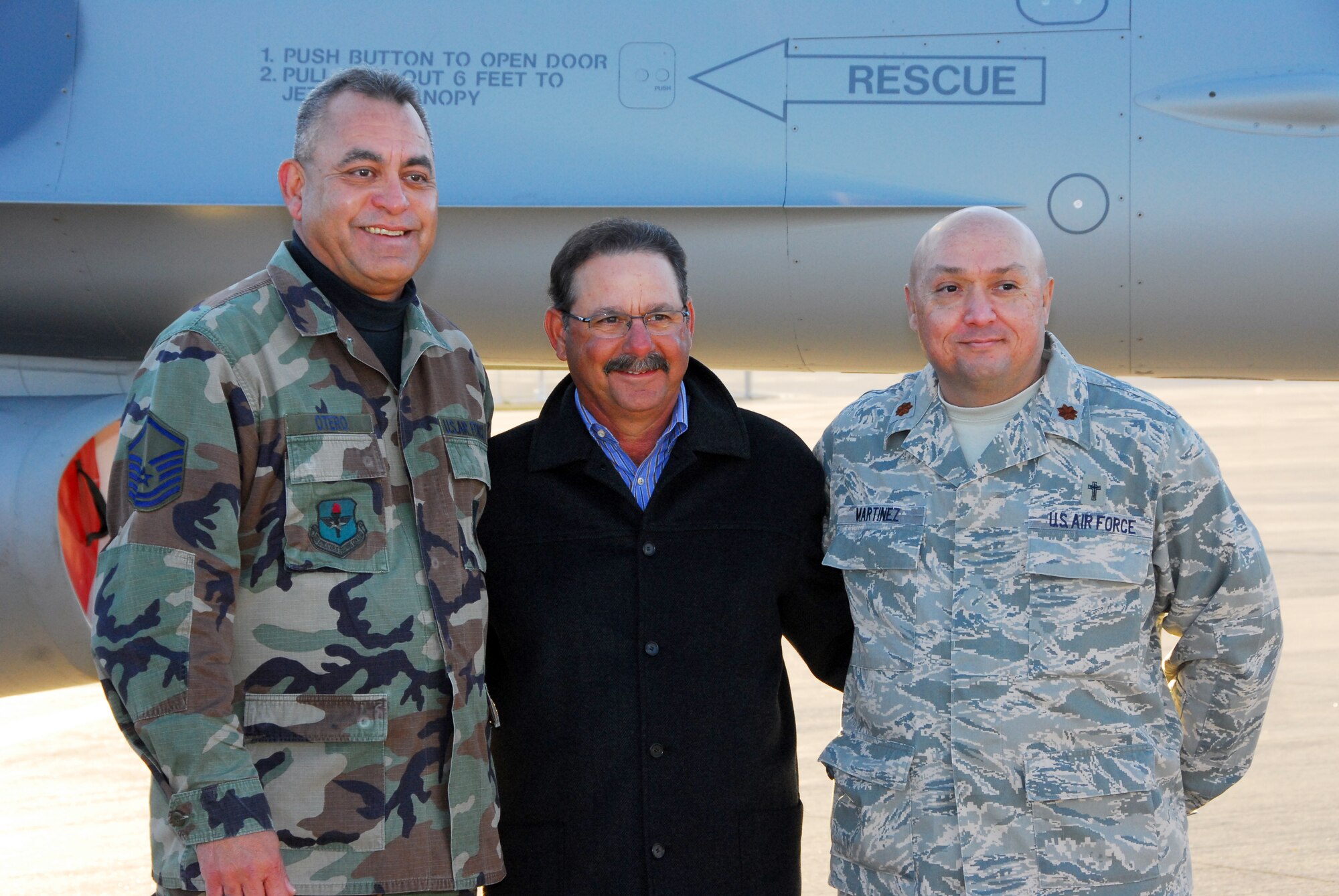 Master Sgt. Bert Otero and Chaplain (Maj.) Mike Martinez take a photograph with University of Arizona Softball Coach Mike Candrea. Coach Candrea was the U.S. Olympic Softball coach in 2004 and 2008, and he led teams to eight NCAA championships during his coaching career. (Air National Guard photo by Master Sgt. Dave Neve)
