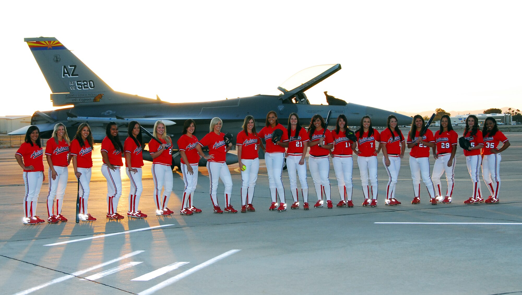 The University of Arizona Softball Team visited the 162nd Fighter Wing of the Arizona Air National Guard Jan. 27 to take photographs for the team’s 2009 season poster. All 19 athletes visited the flightline at Tucson International Airport for a sunrise portrait with an F-16 Fighting Falcon. According to University officials, the posters will be printed by March and will be available free of charge at the Athletic Department offices at McKale Memorial Center. (Air National Guard photo by Master Sgt. Dave Neve)