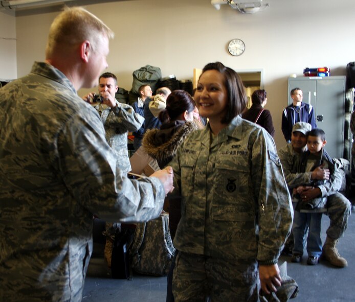 WRIGHT-PATTERSON AFB, Ohio - Chaplain (Capt.) Jonathan Kollmann, 445th Airlift Wing, shakes hands with Senior Airman Stacie Crawford, 445th Security Forces Squadron, before she departs on a six month deployment to Southwest Asia. The security forces squadron deployed 18 members in December and another 13 more in January. (Air Force photo/Stacy Vaughn) 