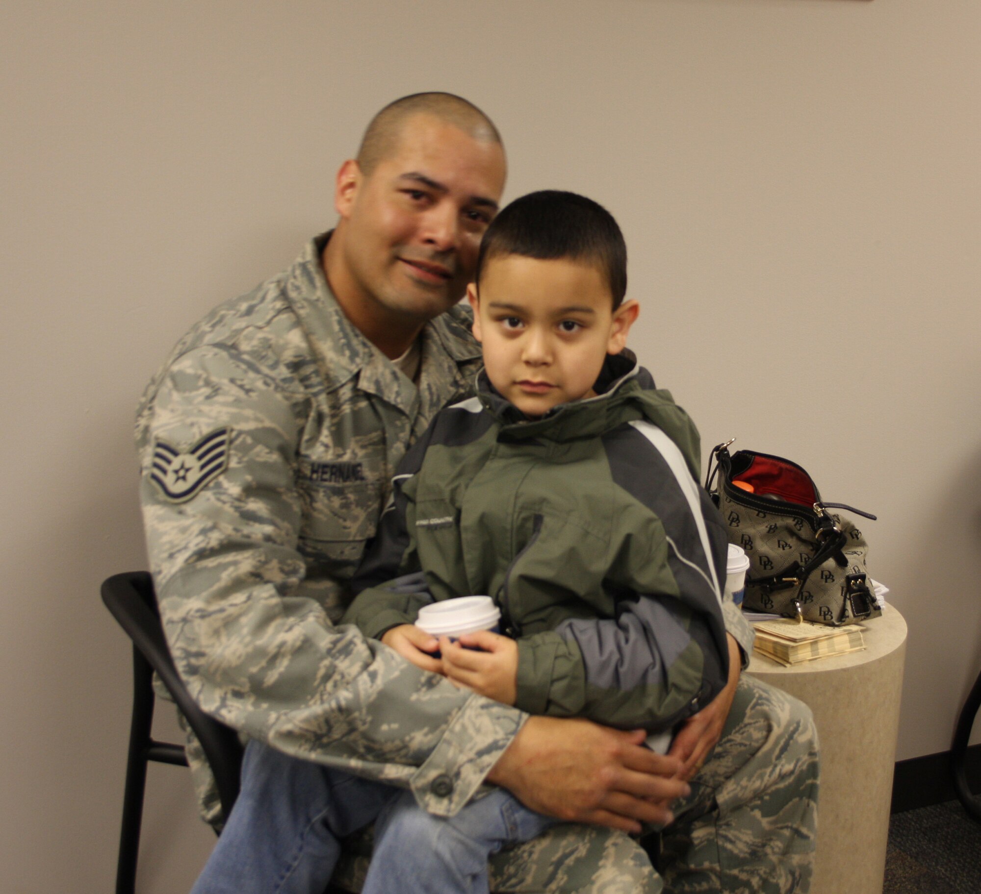 WRIGHT-PATTERSON AFB, Ohio - Staff Sgt. Sonny Hernandez, 445th Security Forces Squadron, spends some quiet time with his son Sonny, Jr. Jan. 23, 2009, before departing on a six month deployment to Southwest Asia. The security forces squadron deployed 18 members in December and another 13 more in January. (Air Force photo/Stacy Vaughn) 
