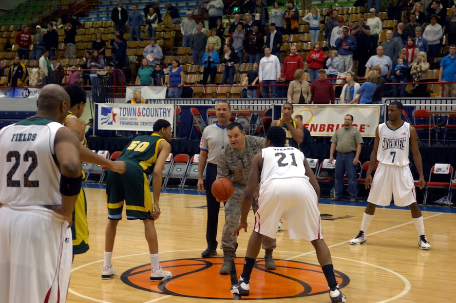 MINOT, N.D. – Col. Christopher Ayres, 91st Missile Wing commander, prepares to toss the opening ball at the Minot Skyrockets Military Appreciation Night basketball game held at the Minot Municipal Auditorium here Jan. 22.  This was the second annual event designed to promote good will and camaraderie between the City of Minot and Minot Air Force Base personnel. (U.S. Air Force photo by Staff Sgt. Keith Ballard)