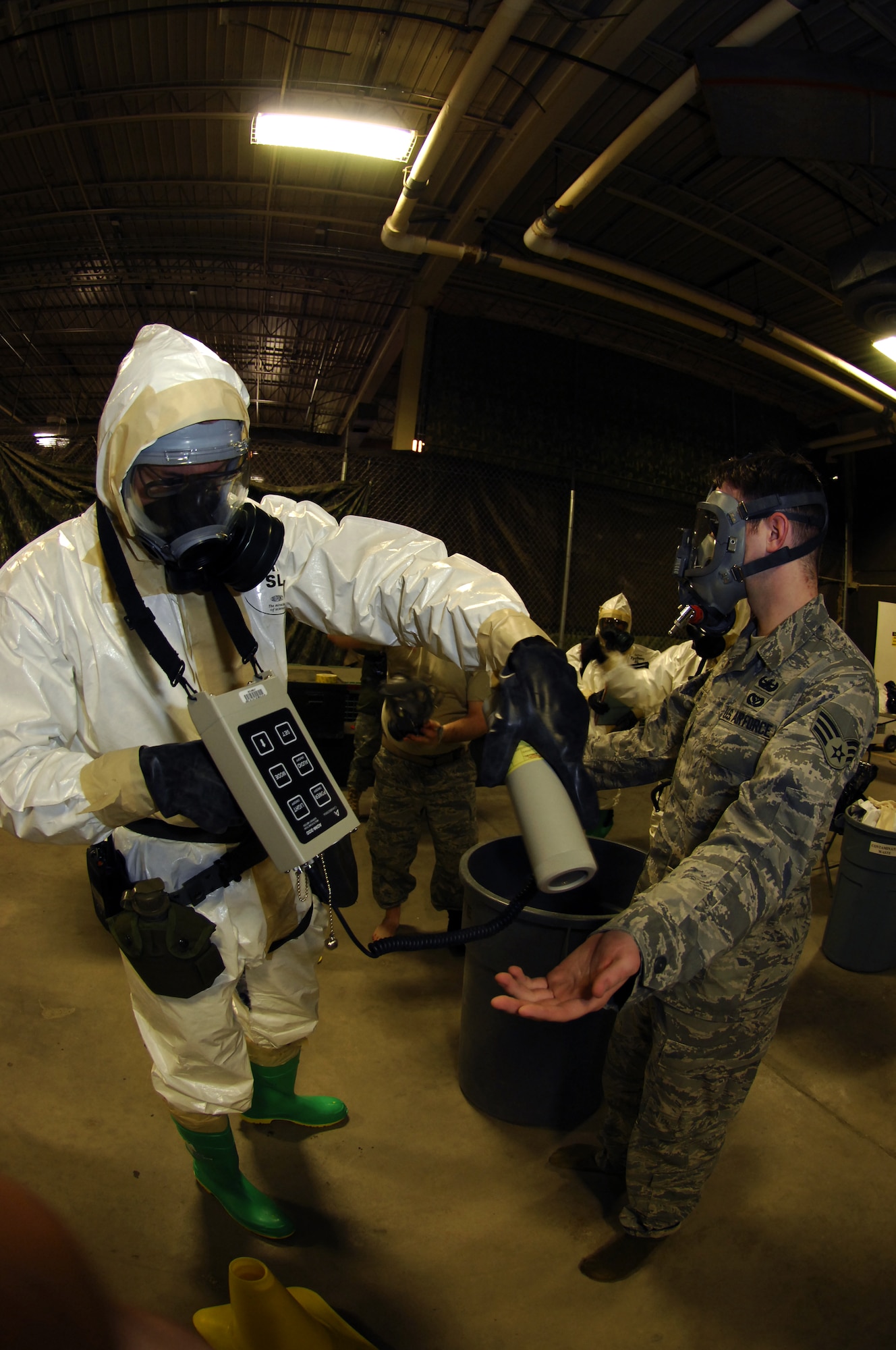 MINOT AIR FORCE BASE, N.D. -- Airman 1st Class Aaron Gardner, 5th Civil Engineer Squadron readiness emergency management team member, checks the radiation level of Senior Airman James Tucci, 5th CES explosive ordnance disposal team member, during the wing exercise Prairie Warrior 09-2 here Jan. 22.  The exercise tested the base's ability to respond to a simulated attack which resulted in a possible chemical spill. (U.S. Air Force photo by Tech. Sgt. Lee A. Osberry Jr.)   