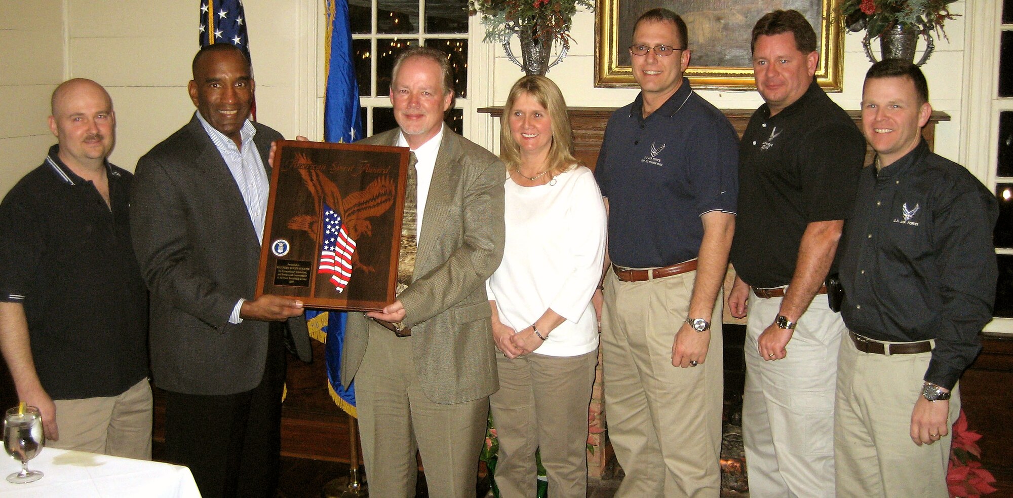 Brig. Gen. A.J. Stewart presents Dennis and Angela Lewis the American Spirit Award during a ceremony Jan. 21 in Perry Ga. Air Force Recruiting Service presented the service's top civic award to program hosts and Southern Woods-N-Water TV for their continued support of Air Force recruiting. Representing the 336th Recruiting Squadron at the presentation were, from left, Master Sgt. Billy Farmer, Tech. Sgt. Thad Smith, Master Sgt. Robert Dixon and Lt. Col. Richard Van Hook. General Stewart is the commander for AFRS. (Courtesy photo) 
