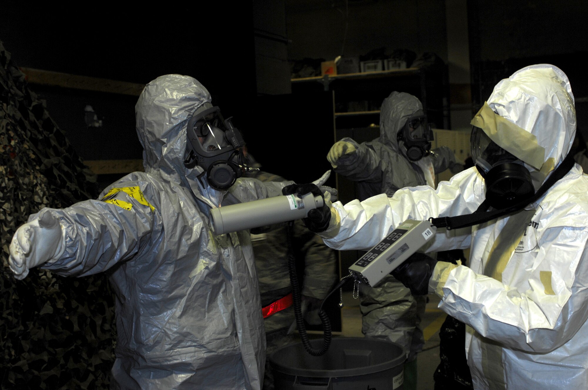 MINOT AIR FORCE BASE, N.D. -- Senior Airman Aaron Feil, 5th Civil Engineer Squadron explosive ordnance disposal team member, is checked for radiation by Senior Airman Danyette Williams, 5th CES readiness emergency management team member, during the Prairie Warrior 09-2 wing exercise here Jan. 22. The exercise tested the base's ability to respond to a simulated attack which resulted in a possible chemical spill. (U.S. Air Force photo by Tech. Sgt. Lee A. Osberry Jr.)   