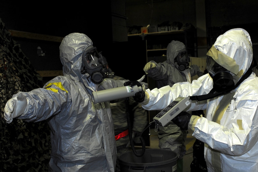 MINOT AIR FORCE BASE, N.D. -- Senior Airman Aaron Feil, 5th Civil Engineer Squadron explosive ordnance disposal team member, is checked for radiation by Senior Airman Danyette Williams, 5th CES readiness emergency management team member, during the Prairie Warrior 09-2 wing exercise here Jan. 22. The exercise tested the base's ability to respond to a simulated attack which resulted in a possible chemical spill. (U.S. Air Force photo by Tech. Sgt. Lee A. Osberry Jr.)   