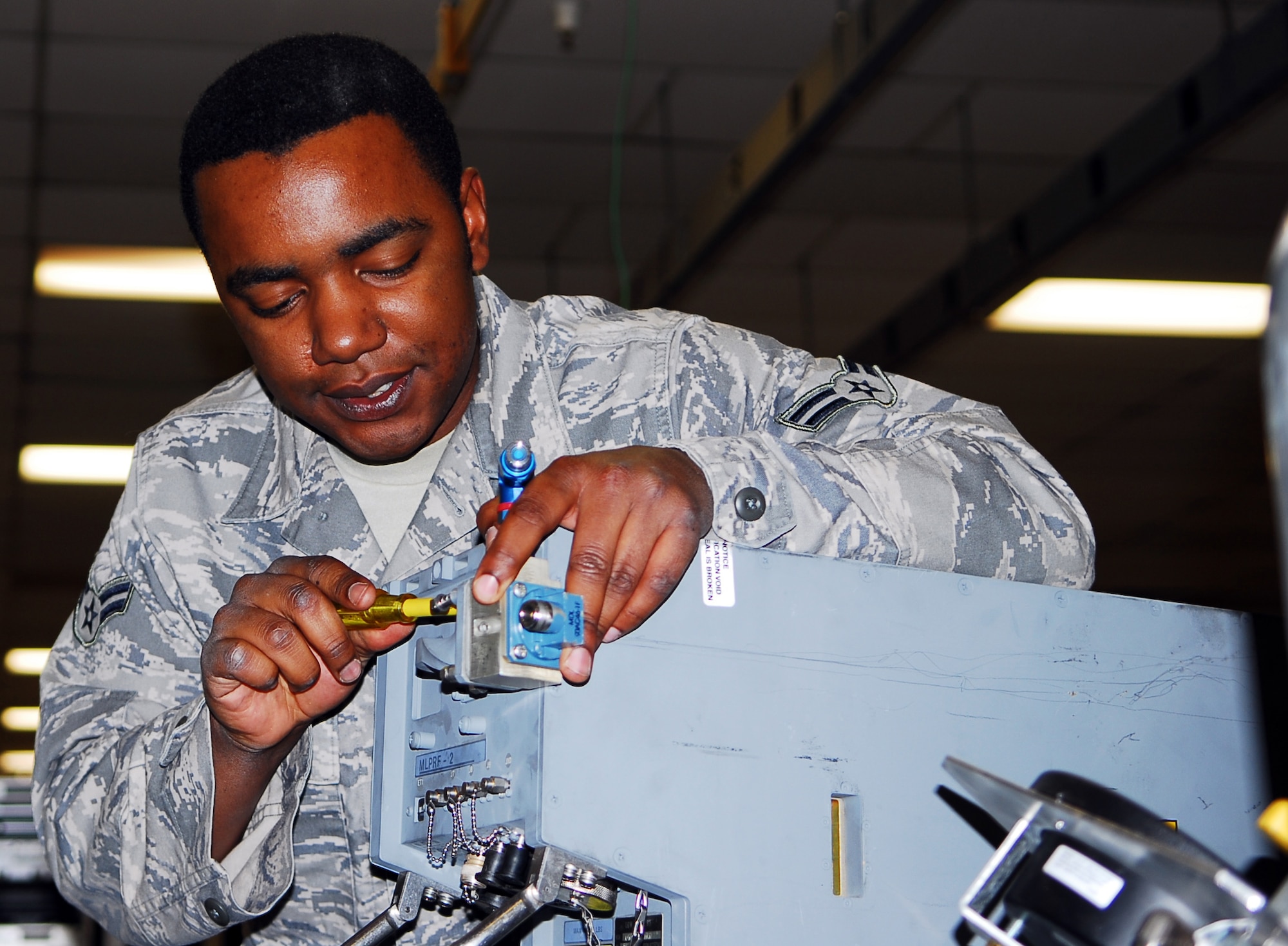 Airman 1st Class Charles Floyd, 56th Component Maintenance Squadron avionics intermediate systems shop team member, attaches a waveguide test valve to a modular low power frequency radar component January 26 in the AIS back shop. The MLPRF uses wave guides to focus radio frequencies for the fire control radar. (Air Force photo by Staff Sgt. Phillip Butterfield)
