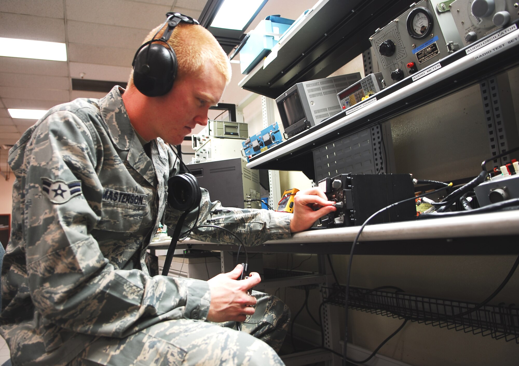 Airman 1st Class Andrew Masterson, 56th Component Maintenance Squadron avionics intermediate systems shop team member, tests an ultra high frequency radio January 26 in the AIS back shop. The UHF radio is the primary means of radio communication in military aircraft. (Air Force photo by Staff Sgt. Phillip Butterfield)