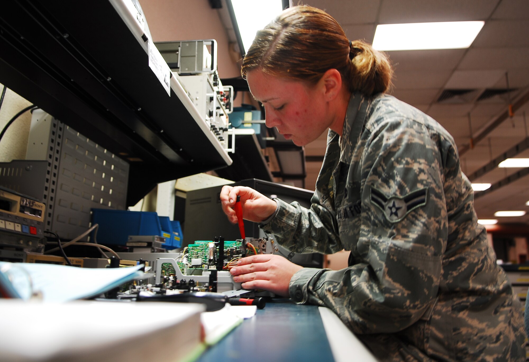Airman 1st Class Brittney Pereira, 56th Component Maintenance Squadron avionics intermediate systems shop team member, disassembles an airborne video tape recorder carriage January 26 in the AIS back shop. The AVTR is used to record flight information for later analysis. (Air Force photo by Staff Sgt. Phillip Butterfield)