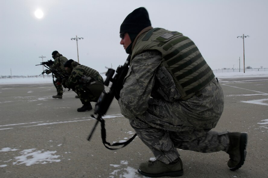 MINOT AIR FORCE BASE, N.D. -- 5th Security Forces members endure the harsh cold during a Blue Coach Training Initiative training scenario here Jan 8. U.S. Navy SEALs will help train a total of 200 Minot AFB security forces members on recapturing and combat tactics by the end of April. (U.S. Air Force photo by Airman 1st Class Jesse Lopez)