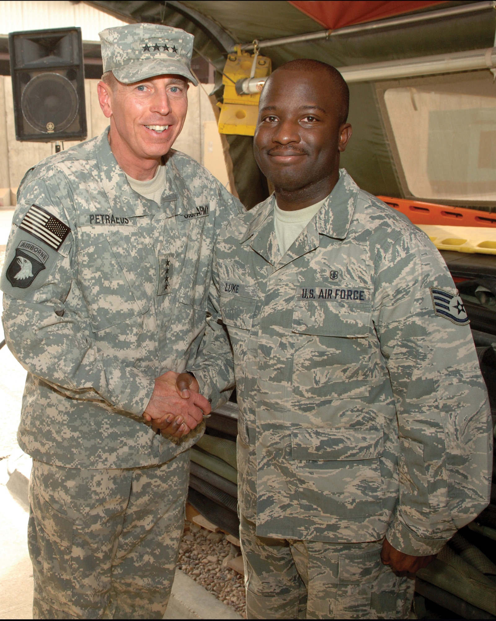 Army Gen. David Petraeus, then-commander Multinational Force Iraq, congratulates Staff Sgt. Otis Luke after presenting the medic with one of his commander's coins. The sergeant thwarted an escape attempt by a dangerous terrorist during a 120-day deployment to Joint Base Balad, Iraq from mid-May to late-September 2008.(U.S. Army Photo)