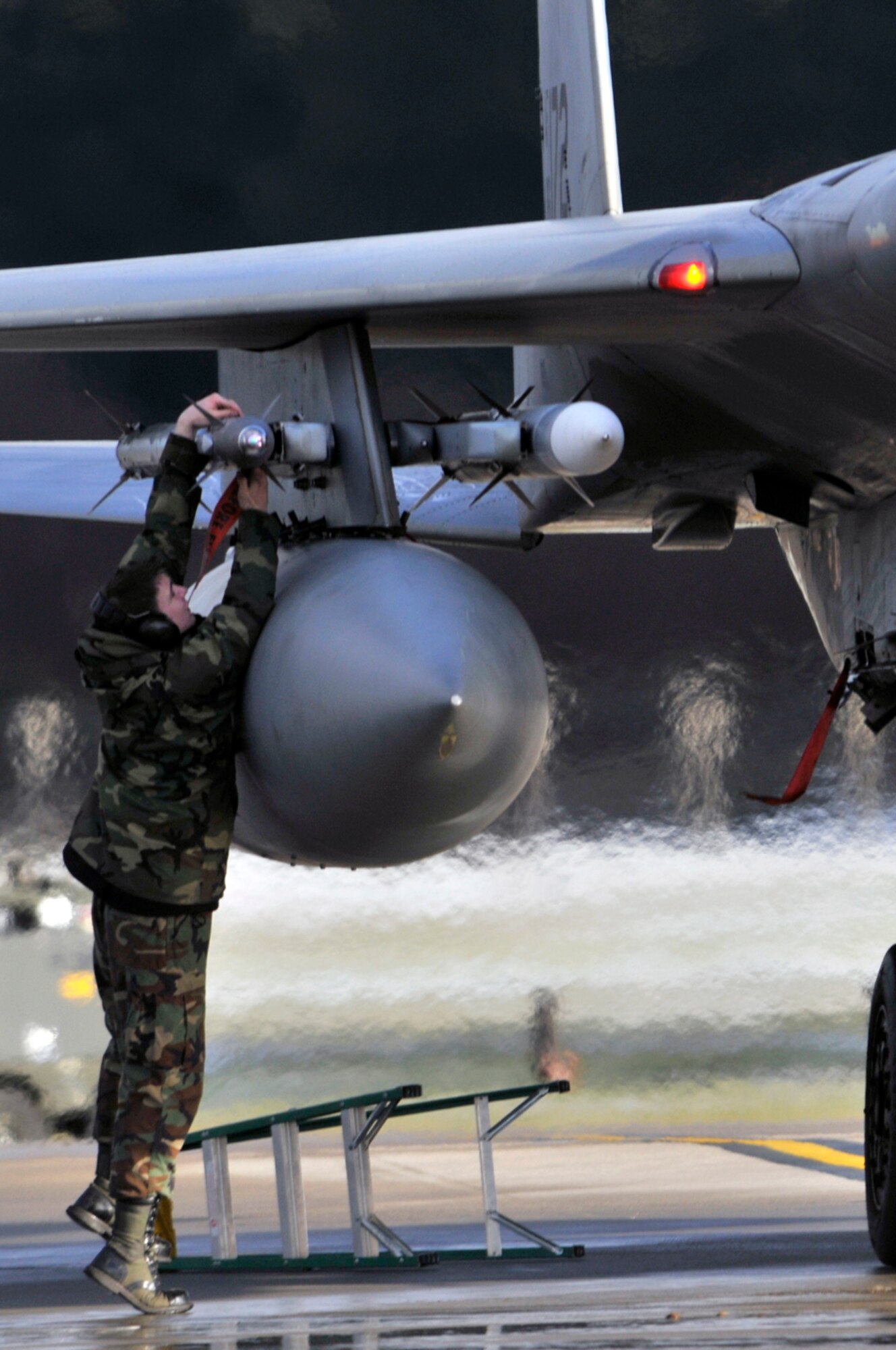 Senior Airman William Pond, 48th Munitions Squadron weapons load crew member, disarms an AIM-9 Sidewinder on an F-15 Eagle, Jan. 5 at RAF Lakenheath, England. The 493rd Fighter Squadron had just returned from Lithuania, after being deployed there for three months to participate in the NATO Baltic Air Policing mission. (U.S. Air Force photo by Airman 1st Class Perry Aston)