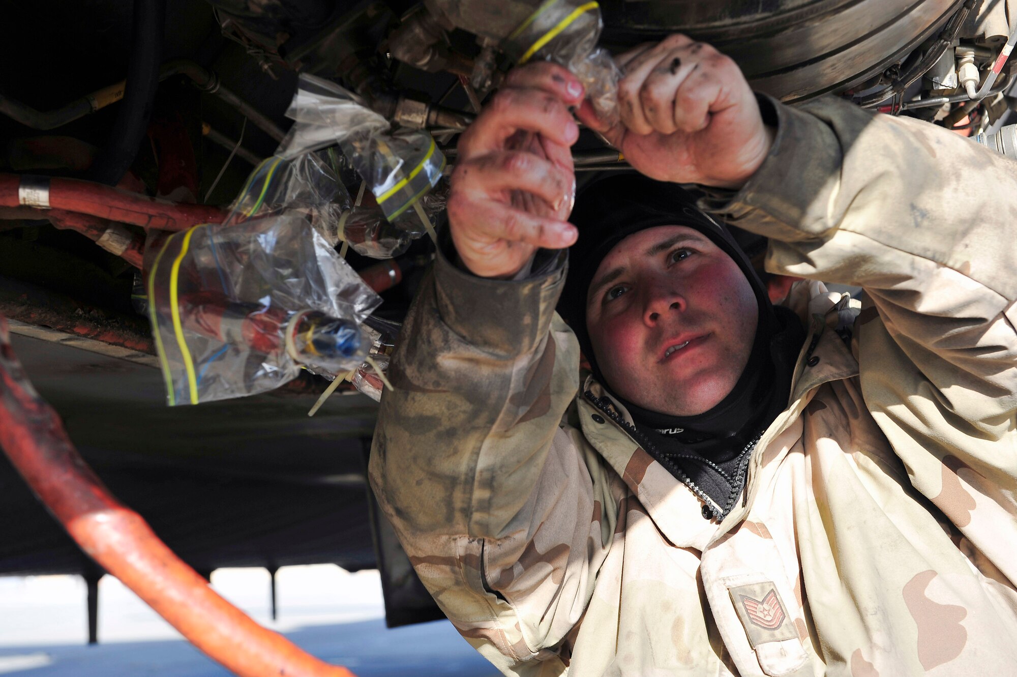 Technical Sgt. Sam Harmon caps the oil and fuel lines before changing the auxiliary power unit of a C-130 Hercules Jan. 16 at Joint Base Balad, Iraq. Sergeant Harmon is a 777th Expeditionary Aircraft Maintenance Unit jet engine mechanic deployed from Little Rock Air Force Base, Ark. He is a native of Santa Barbara, Calif. (U.S. Air Force photo/Senior Airman Elizabeth Rissmiller) 
