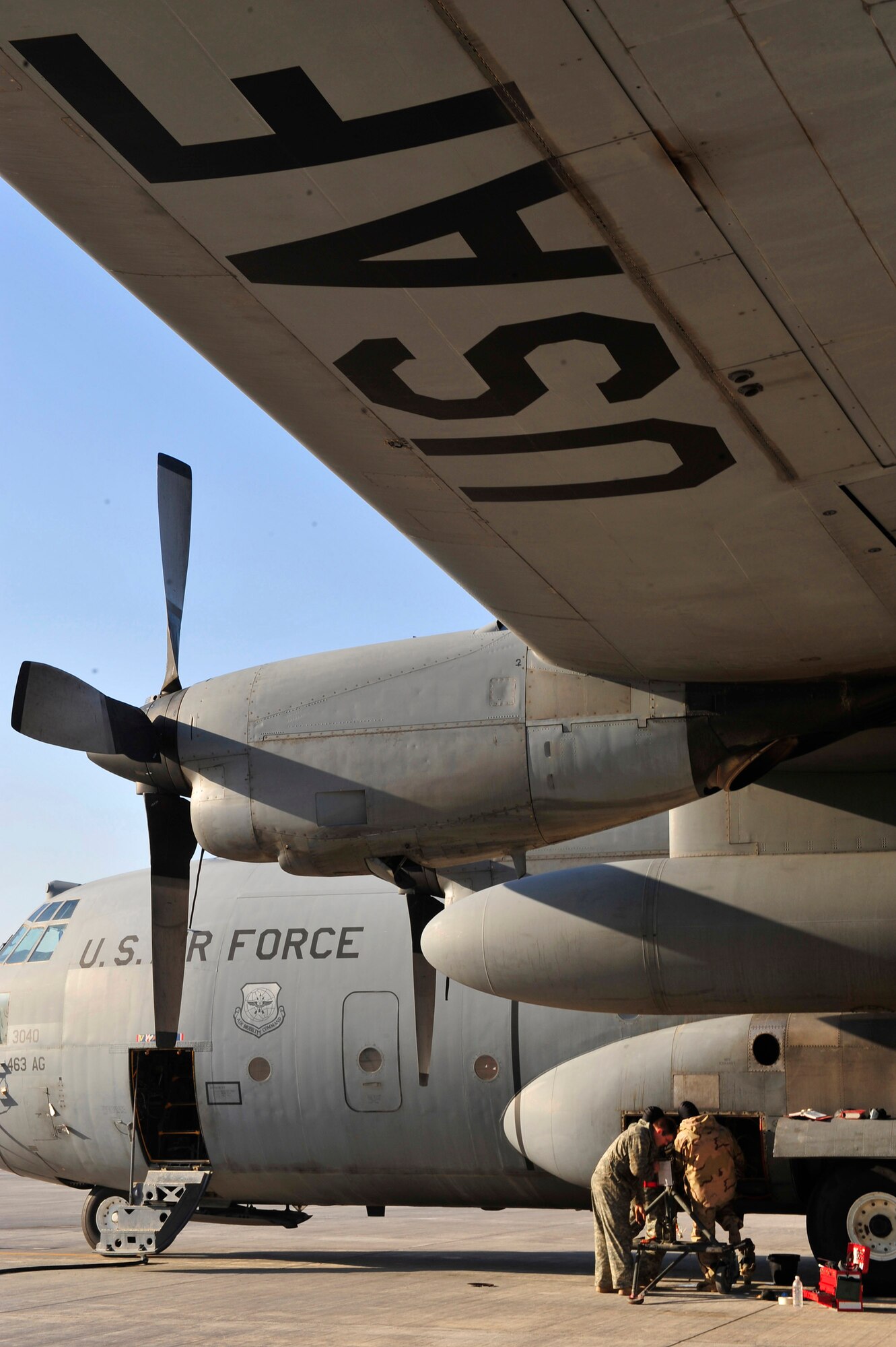 Technical Sgt. Sam Harmon, Senior Airman Billy Howell and Airman 1st Class Ryan Sluss change an auxiliary power unit of a C-130 Hercules Jan. 16 at Joint Base Balad, Iraq. Sergeant Harmon and Airman Howell are 777th Expeditionary Aircraft Maintenance Unit jet engine mechanics. Airman Sluss is a 777th EAMU crew chief. They are all deployed from Little Rock Air Force Base, Ark. (U.S. Air Force photo/Senior Airman Elizabeth Rissmiller) 
