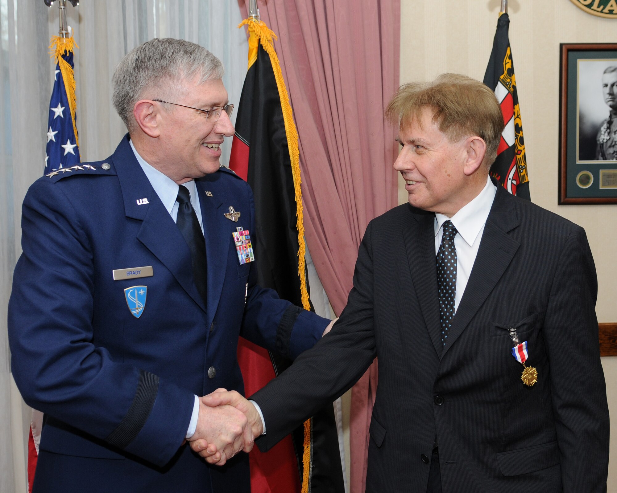 General Roger E. Brady, U.S. Air Forces in Europe commander, presents the USAFE Medal of Distinction to Dr. Richard Auernheimer, former State Secretary of the Ministry for Labor, Social Affairs, Health, Family and Women for the Rhineland-Palatinate State Government, Jan. 22, 2009, at Ramstein Air Base for his unrelenting engagement on behalf of USAFE during the last nine years. Dr. Auernheimer's efforts to develop and expand solid relations between the state government and USAFE fostered the channels of communication and high degree of trust currently existing between USAFE and the state agencies. (U.S. Air Force photo by Airman 1st Class Caleb Pierce)