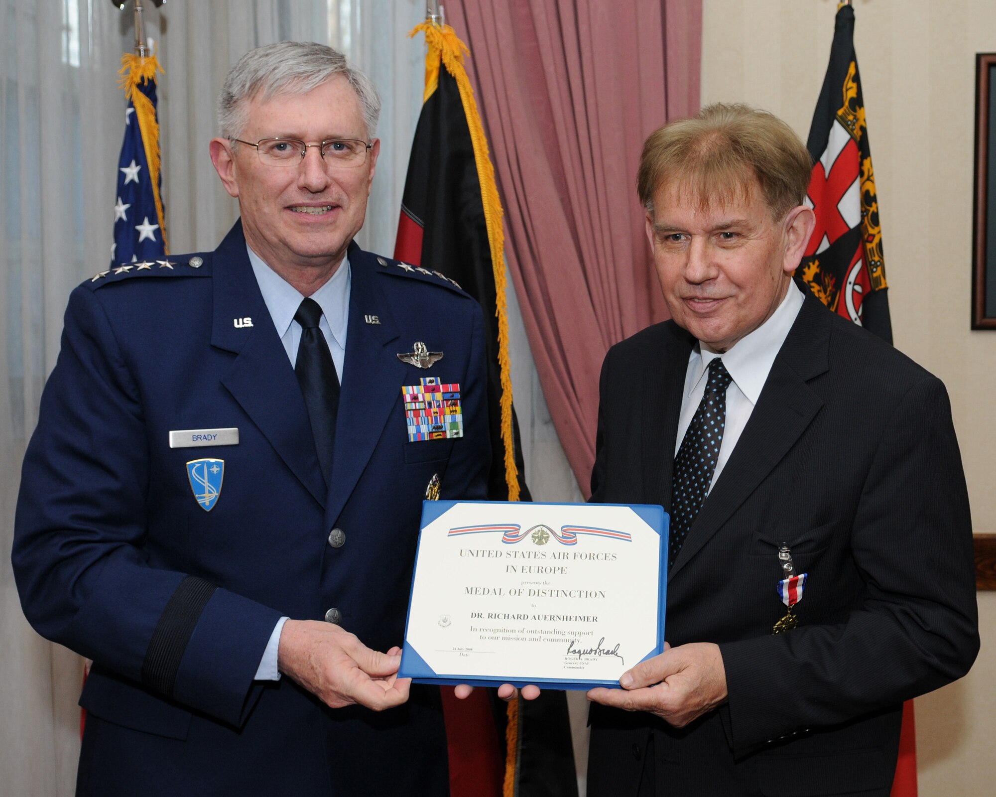 General Roger E. Brady, U.S. Air Forces in Europe commander, presents the USAFE Medal of Distinction certificate to Dr. Richard Auernheimer, former State Secretary of the Ministry for Labor, Social Affairs, Health, Family and Women for the Rhineland-Palatinate State Government, Jan. 22, 2009, at Ramstein Air Base for his unrelenting engagement on behalf of USAFE during the last nine years. Dr. Auernheimer's efforts initiated a new basis of mutual support and partnership between his staff members and USAFE, enabling the integration of both parties in the civil-military cooperation structure between German Armed Forces and state authorities. (U.S. Air Force photo by Airman 1st Class Caleb Pierce)