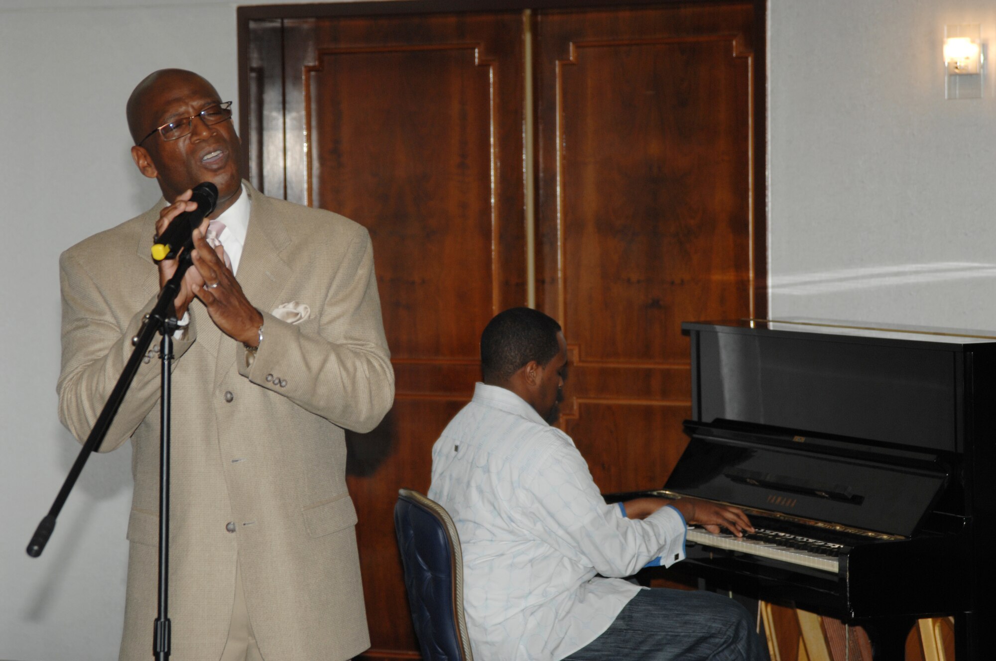 Byron Clark, 39th Force Support Squadron, performs the song “A Change is Gonna Come” with Senior Airman Ian Ramey, 39th Maintenance Squadron, on the piano during the annual Martin Luther King Jr. observance luncheon, Jan. 20, at Incirlik Air Base, Turkey. The song was originally written and performed by the late Sam Cooke and was written to support the civil rights movement. (U.S. Air Force photo/1st Lt. Nick Plante)